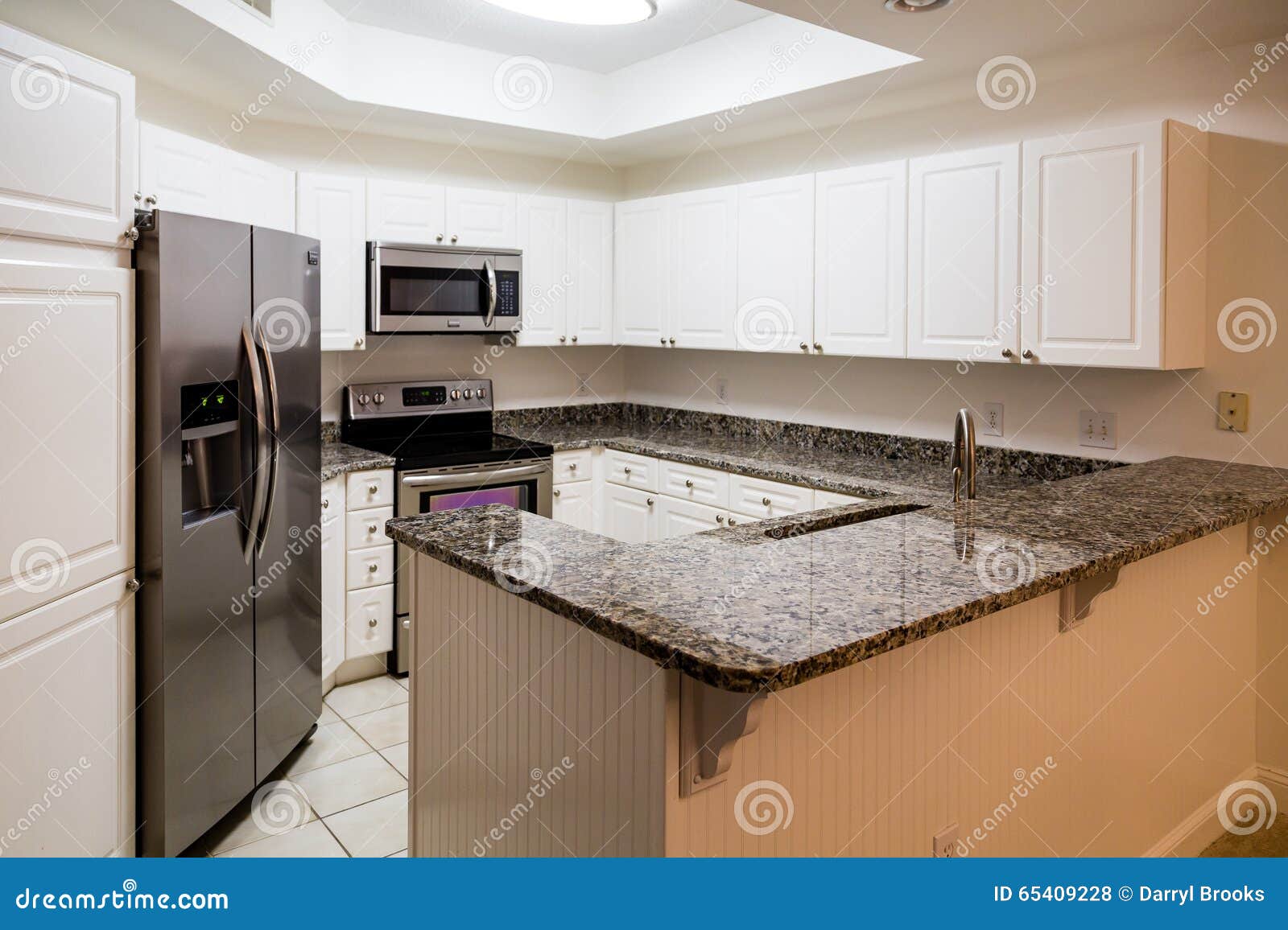 New Stainless Appliances And Granite Counter In White Kitchen