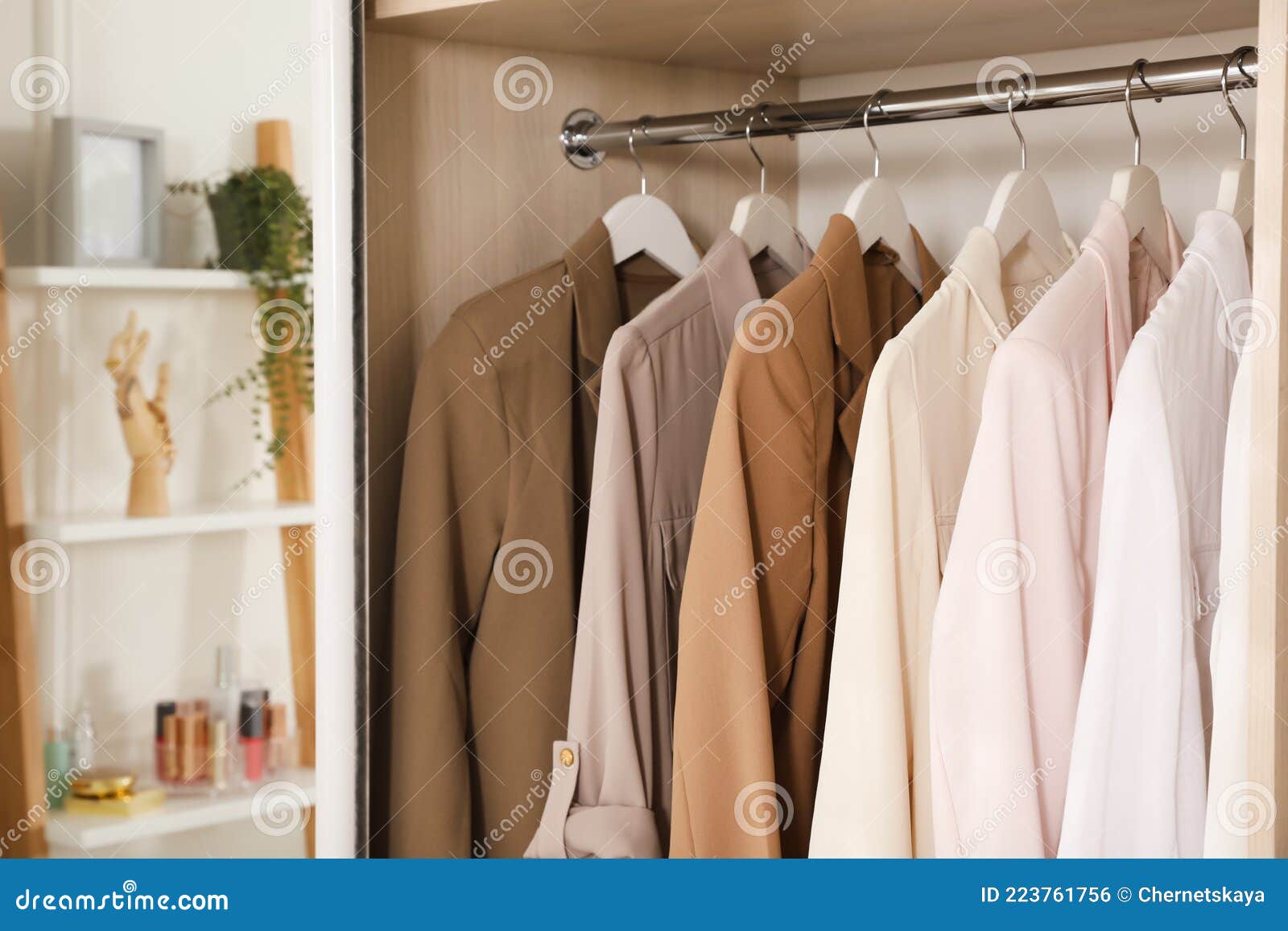 New Stylish Clothes Hanging in Wardrobe, Closeup View Stock Photo