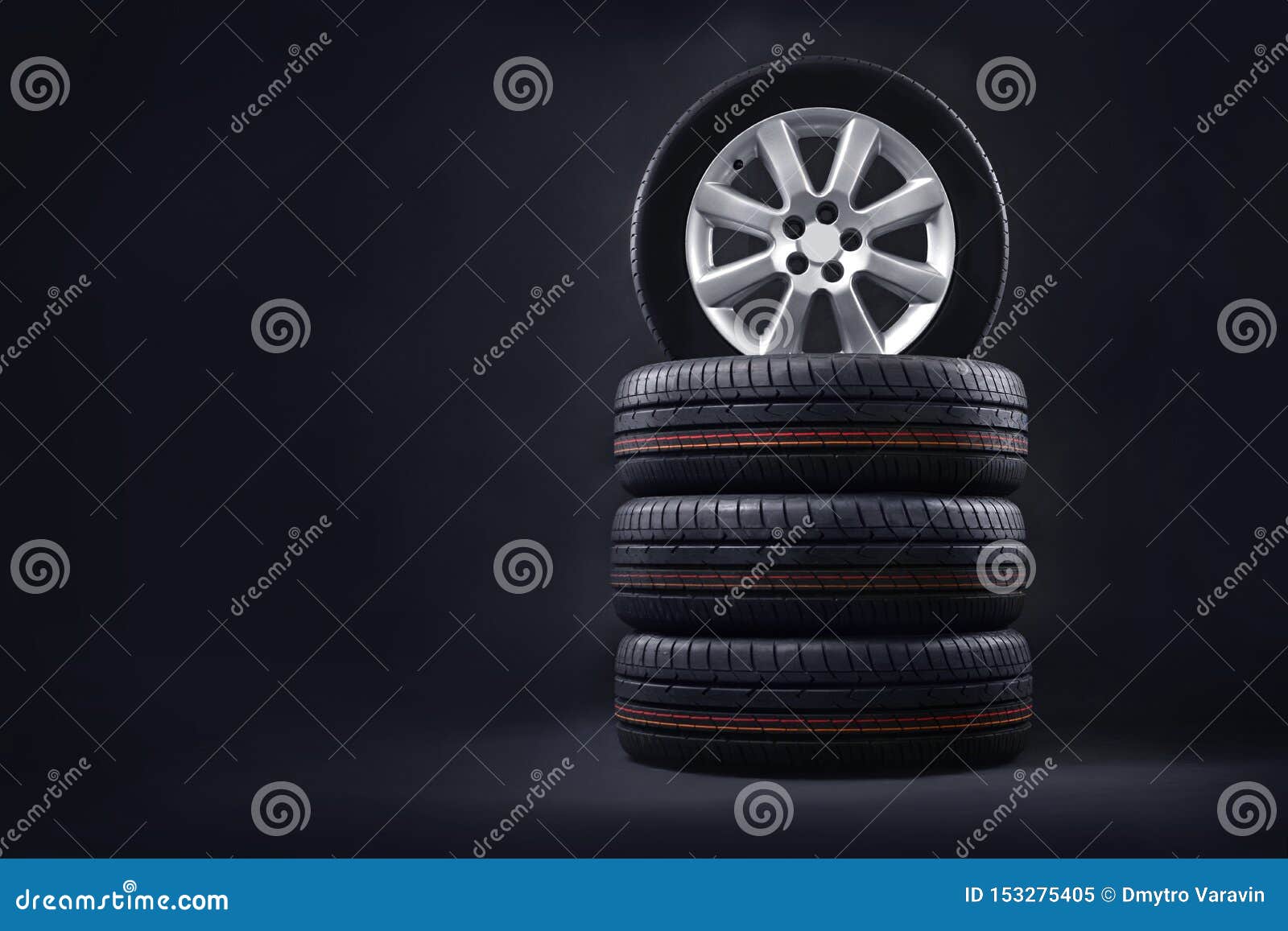 new tires pile on a dark background. tire fitting background.