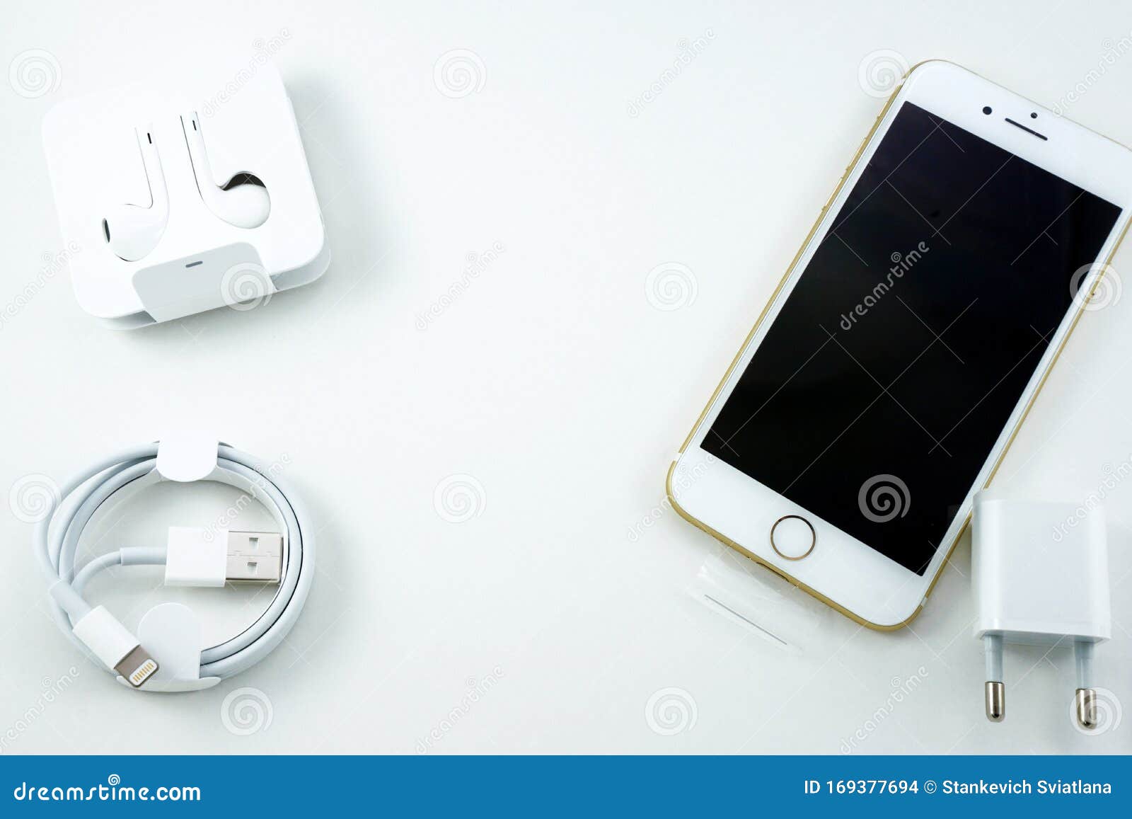 New White Cell Phone and Its Accessories on a White Background. Phone,  Charger, Cable, Headphones. Top View, Flat Stock Photo - Image of mobile,  communication: 169377694