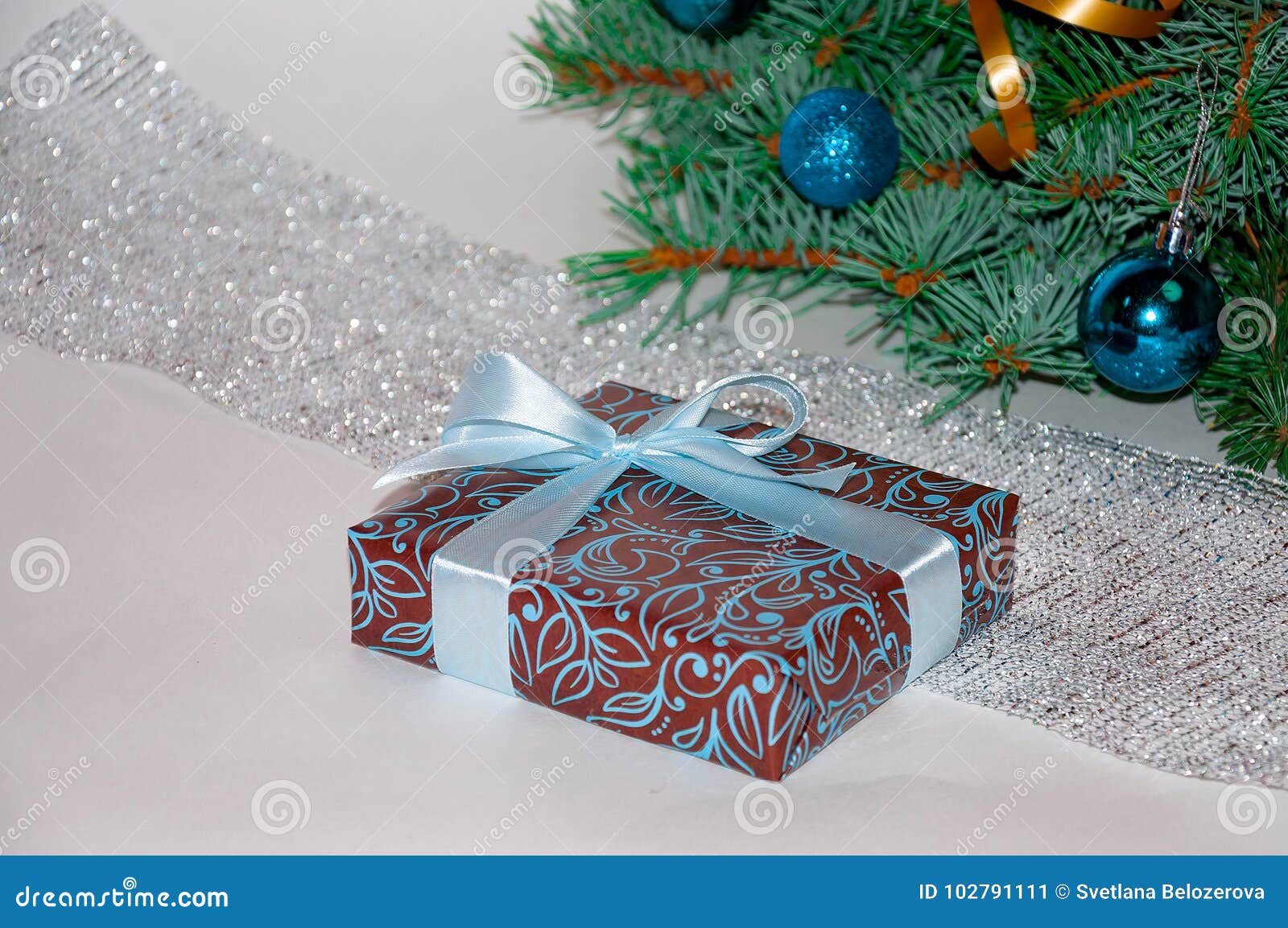 Christmas position Christmas t under the Christmas tree on a white background Christmas presents Blue toys on the Christmas tree and shiny