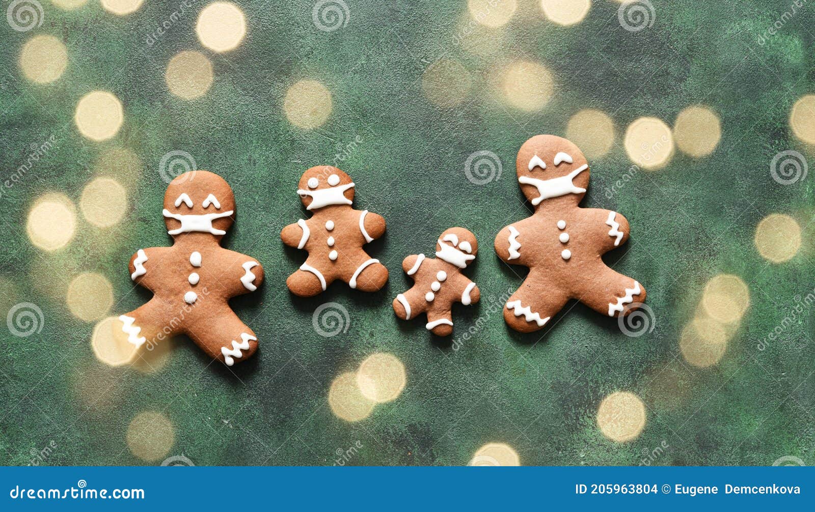 new year concept. gingerbread family in masks on a green concrete background. view from above