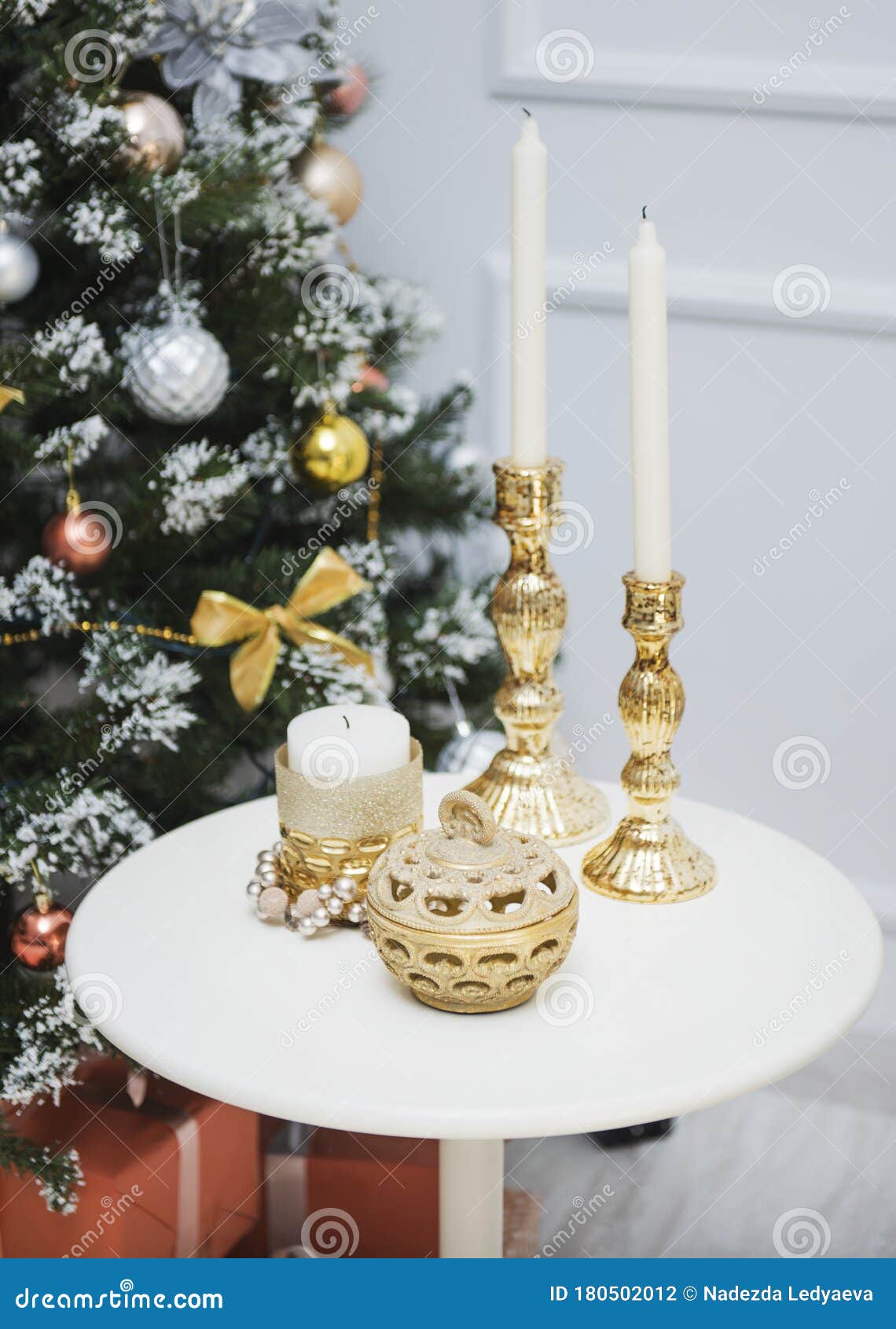New Year Decorations on the Table, Candles in Gold Candlesticks, a Box