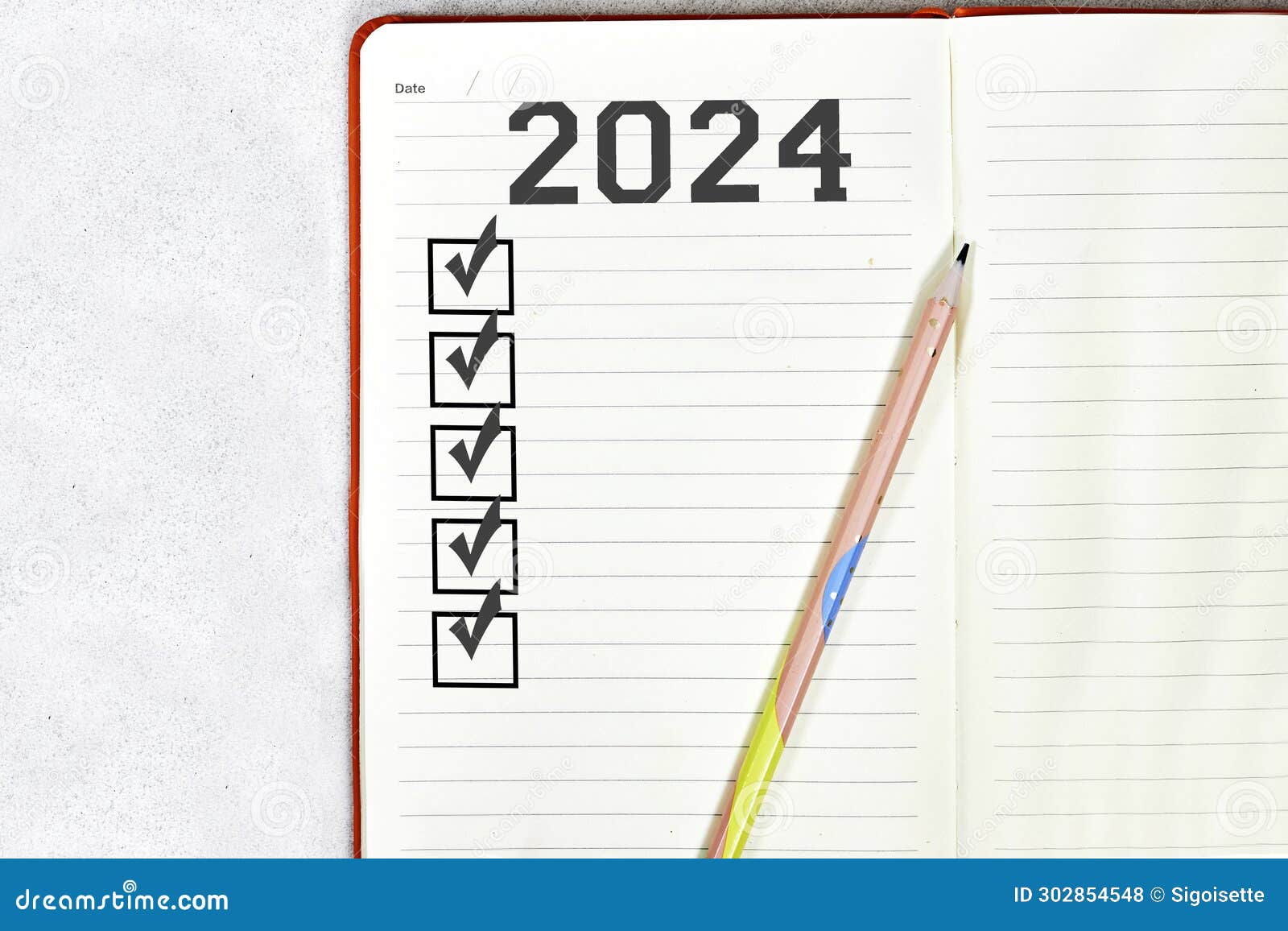 New Year Goals 2024 on Desk. 2024 Goals List with Notebook Stock Photo