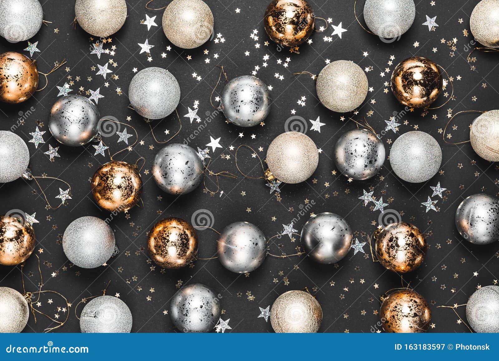 Christmas background with gold and silver decorations on black