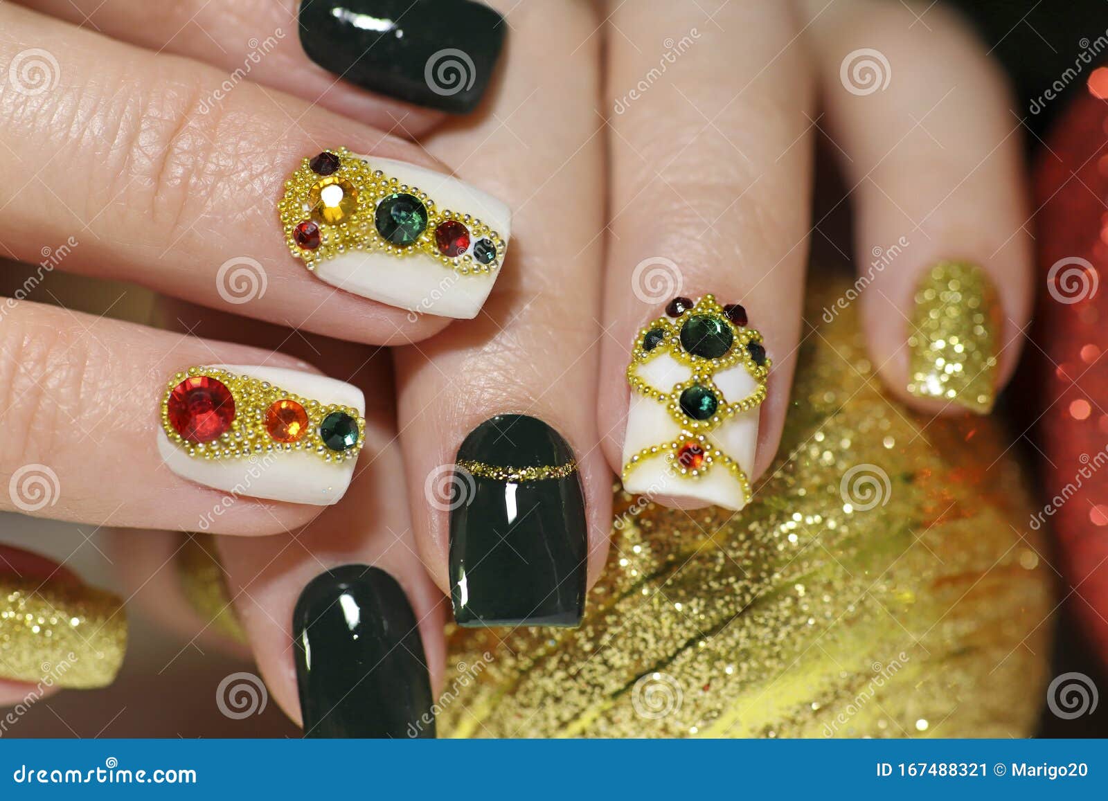 new year`s fashionable beautiful festive manicure on short square nails with green lacquer color.