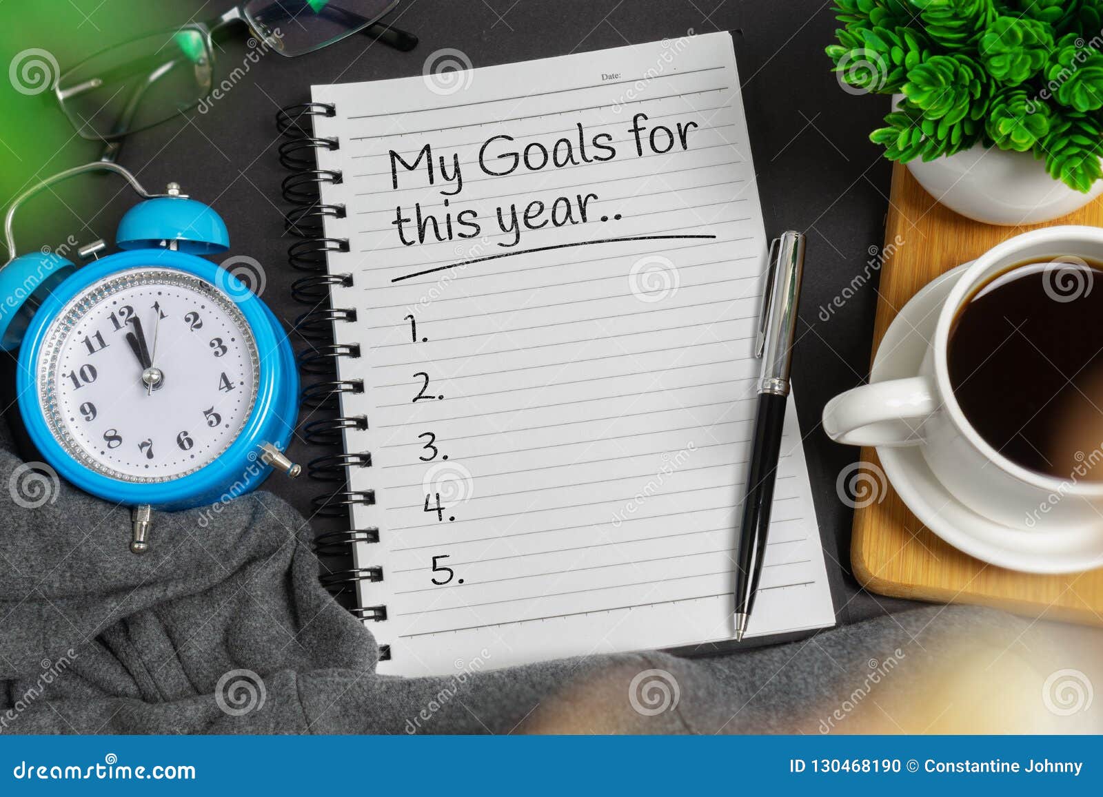 new year`s resolution concept. notepad on black home office desk.