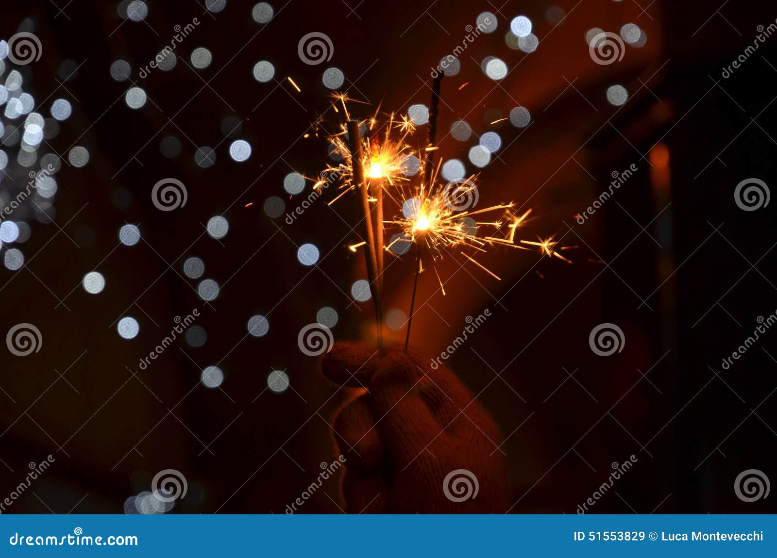new years eve celebration with hand held sparkler fireworks