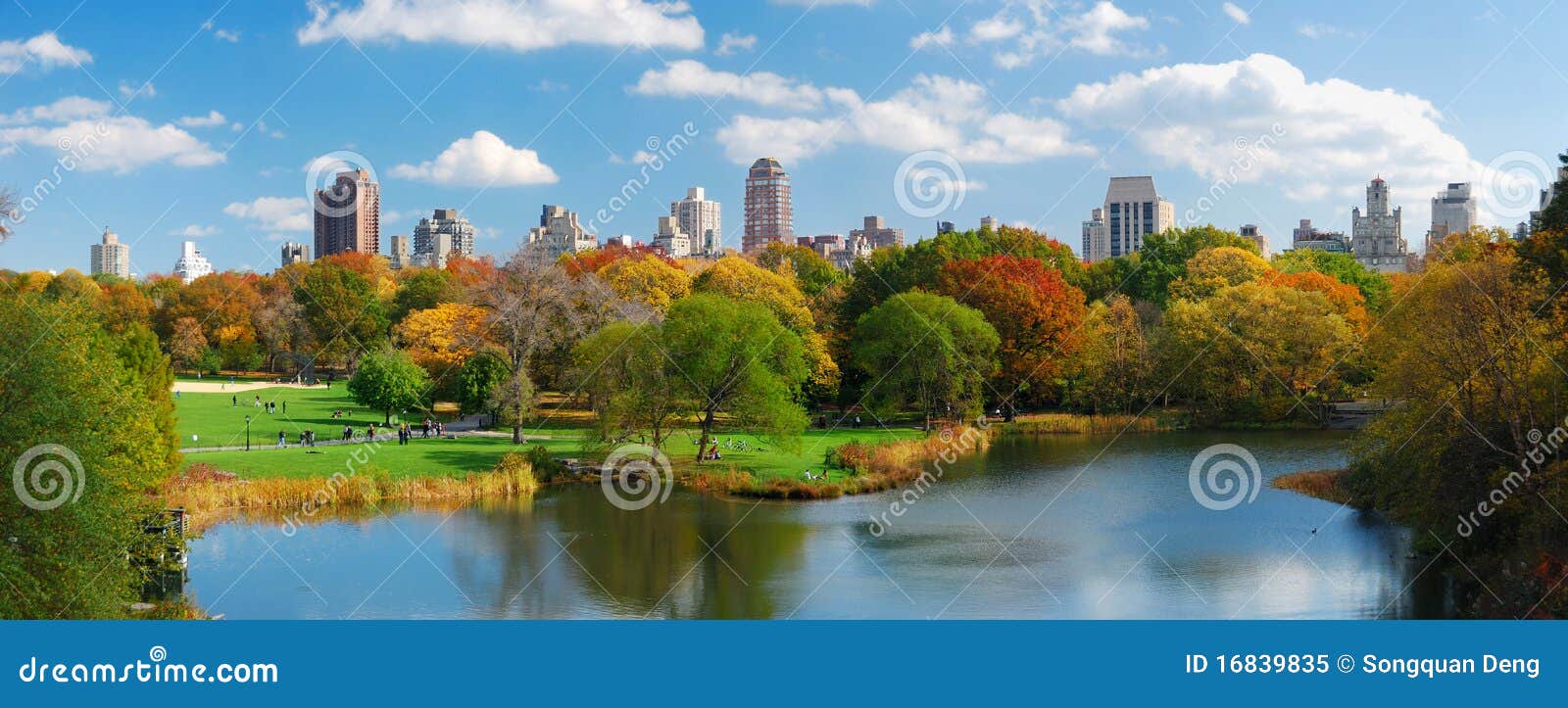 New York City Manhattan Central Park panorama. New York City Central Park panorama view in Autumn with Manhattan skyscrapers and colorful trees over lake with reflection.