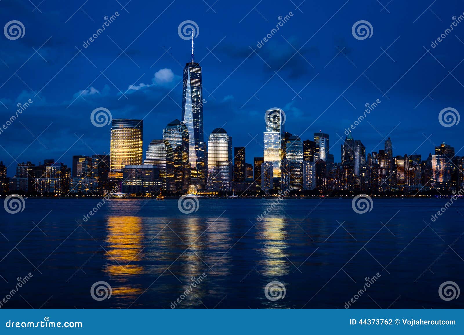 new york city manhattan downtown skyline with skyscrapers illuminated over hudson river panorama