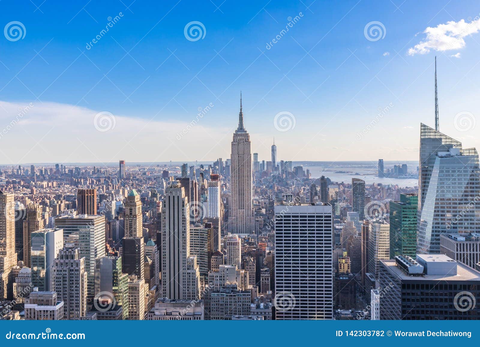 new york city skyline in manhattan downtown with empire state building and skyscrapers on sunny day with clear blue sky usa