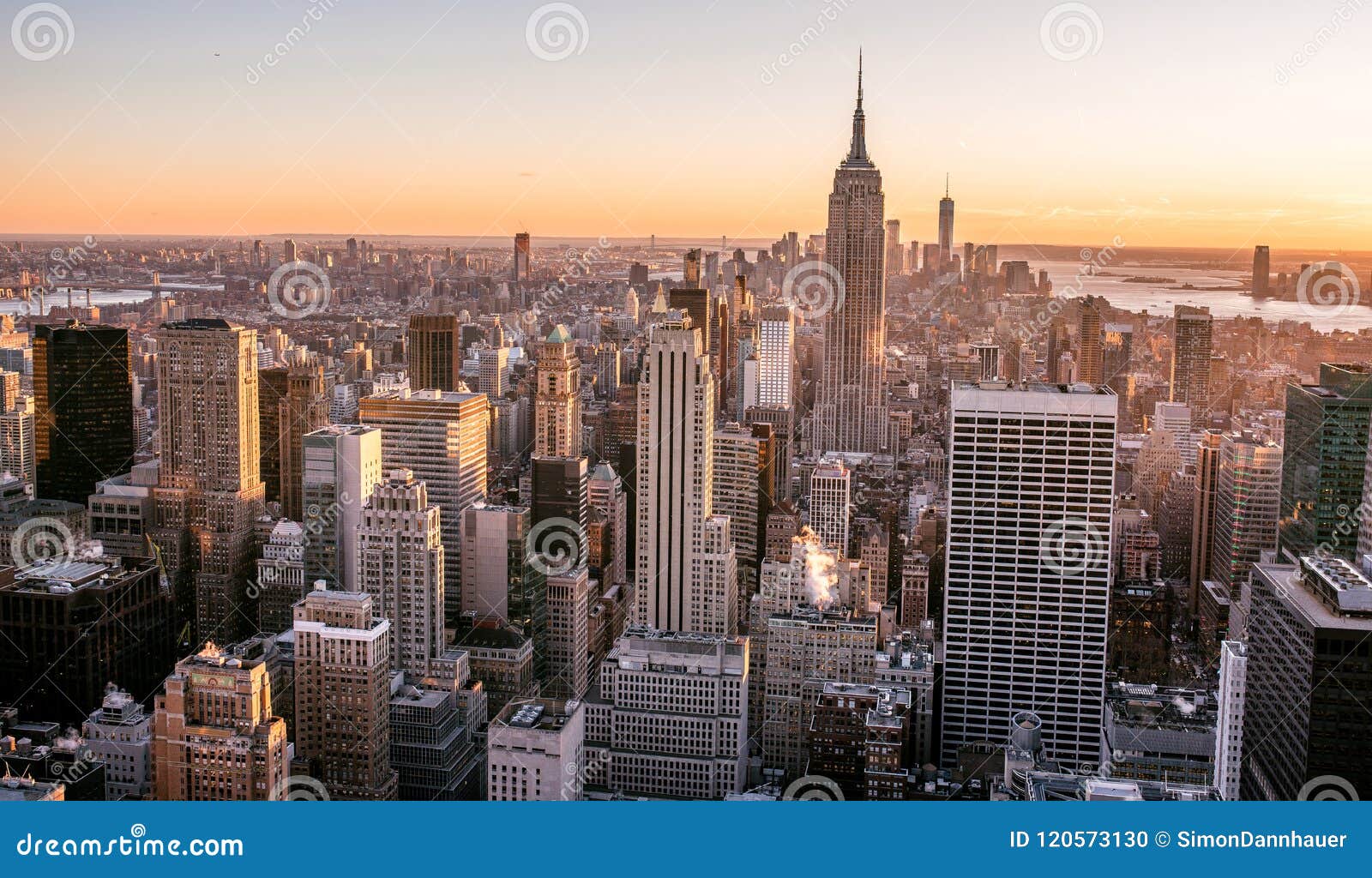 new york city - usa. view to lower manhattan downtown skyline with famous empire state building and skyscrapers at sunset.