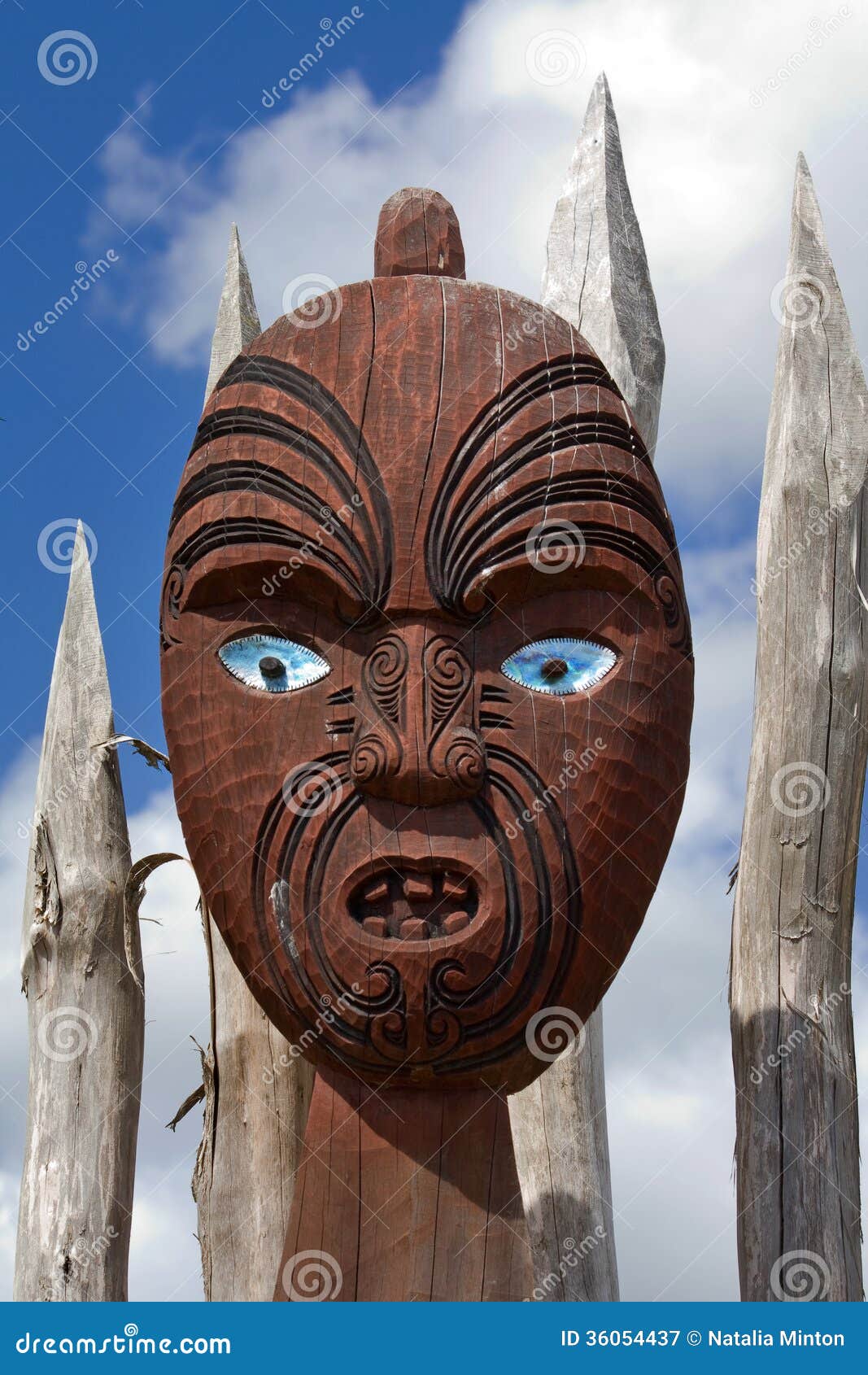 New Zealand maori mask. New Zealand traditional maori wooden mask on the fence