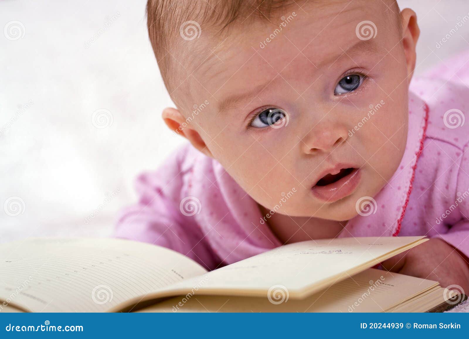 Newborn baby with a book stock image. Image of child 20244939