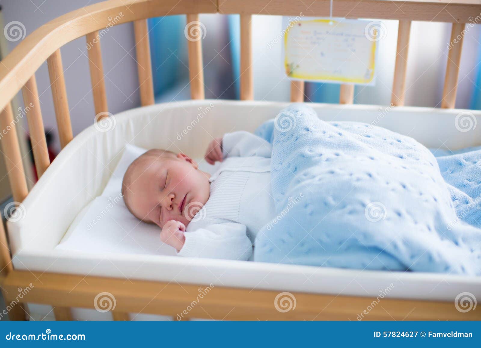  bassinet. Safe co-sleeping in a bed side cot. Little boy taking a nap