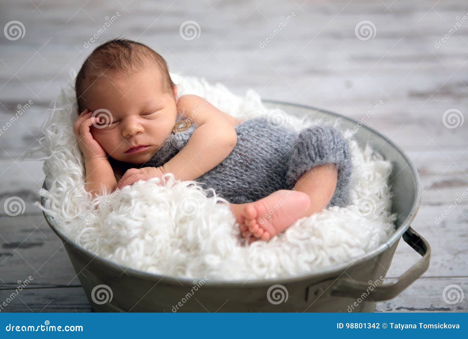 Newborn Baby Boy Sleeping Peacefully In Basket Dressed In Knit Stock