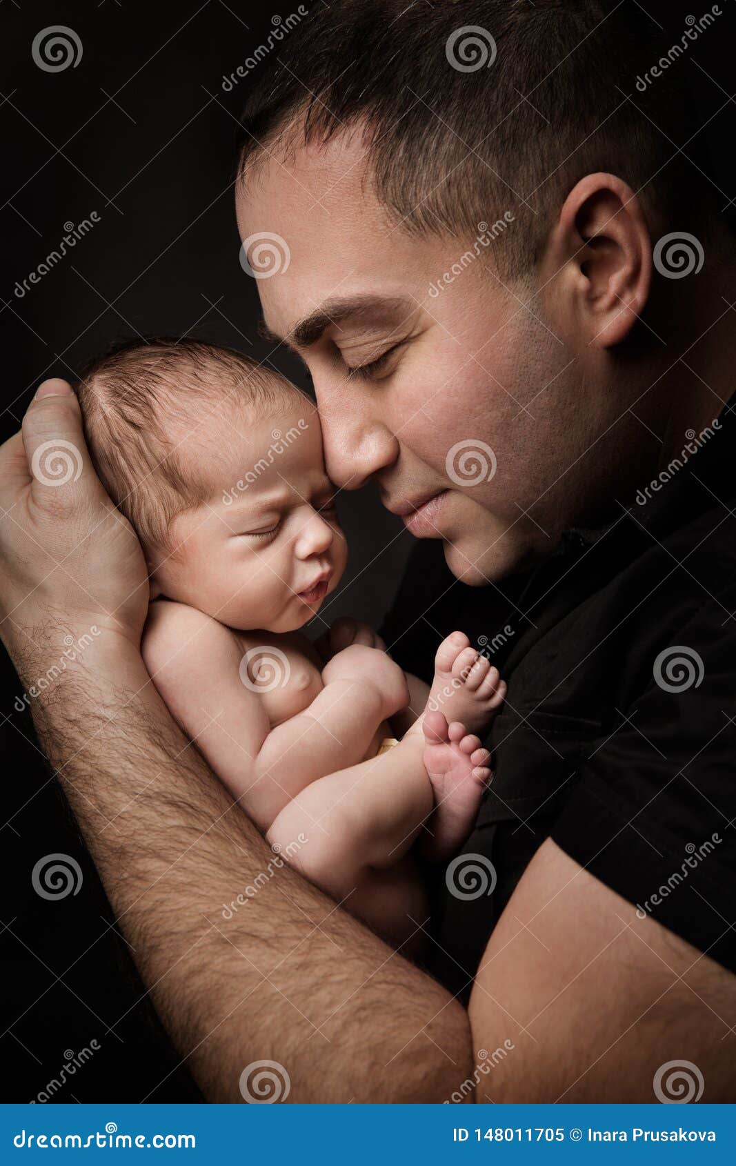 newborn baby and father portrait, man holding new born kid on hands, parents care
