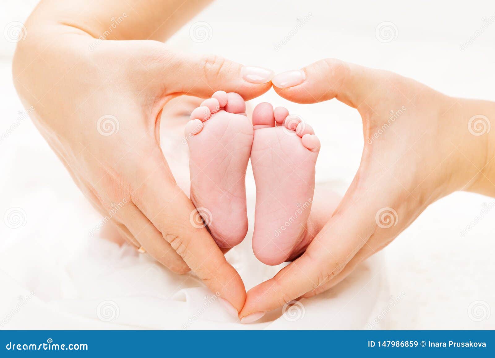 newborn baby feet in mother hands heart, mom and new born kid foot