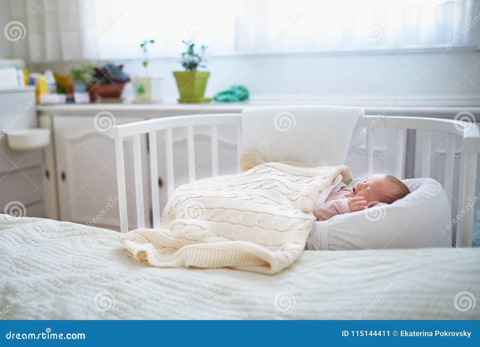 baby sleeper in bed with parents