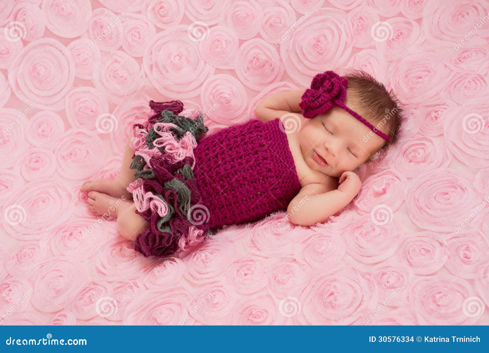 newborn baby girl wearing a crocheted romper