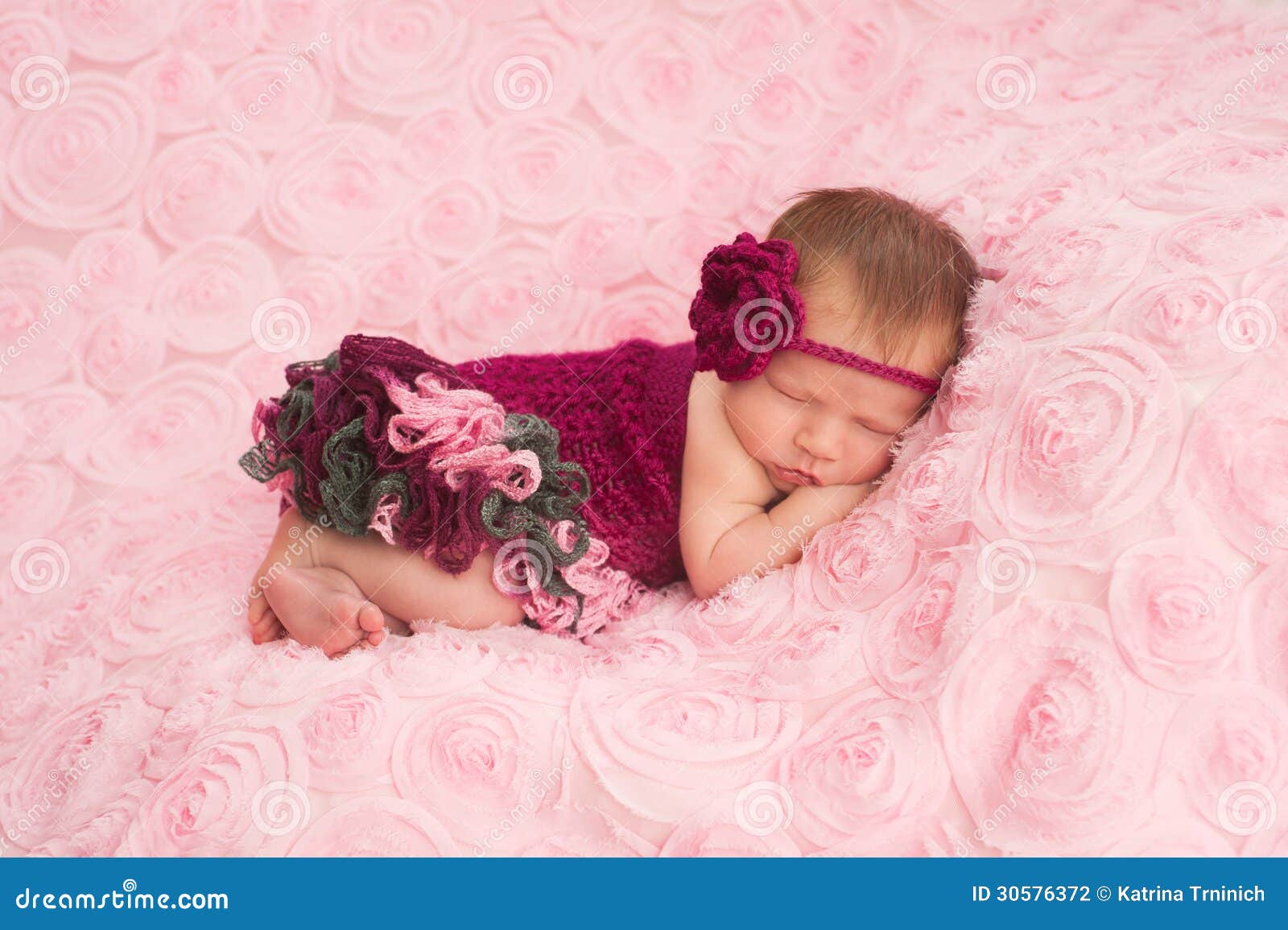 newborn baby girl wearing a crocheted romper