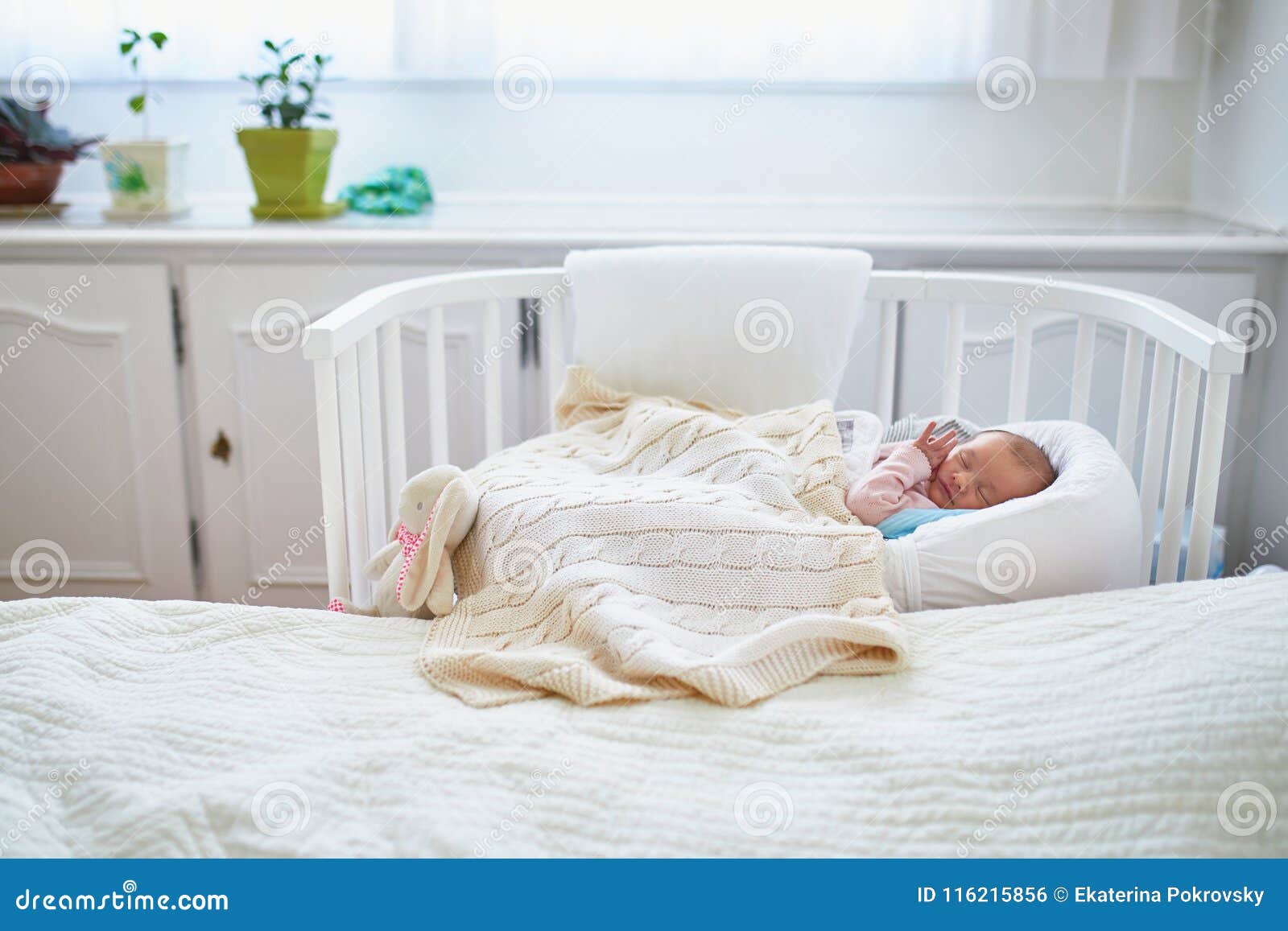 baby crib attached to parents bed