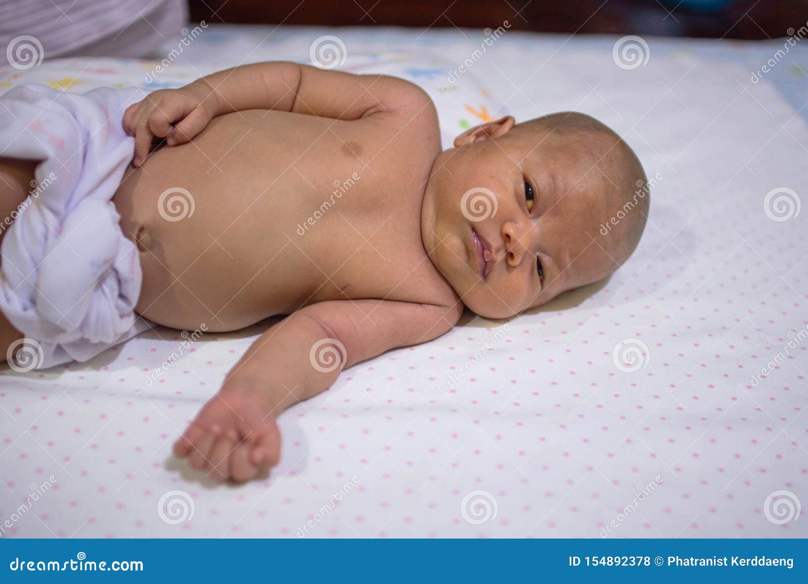 Newborn Baby is Laying on the White Bed. New Born is No Hair. Child is 1  Months. Asian Infant is Wearing White Fabric Diaper Stock Photo - Image of  family, happy: 154892378