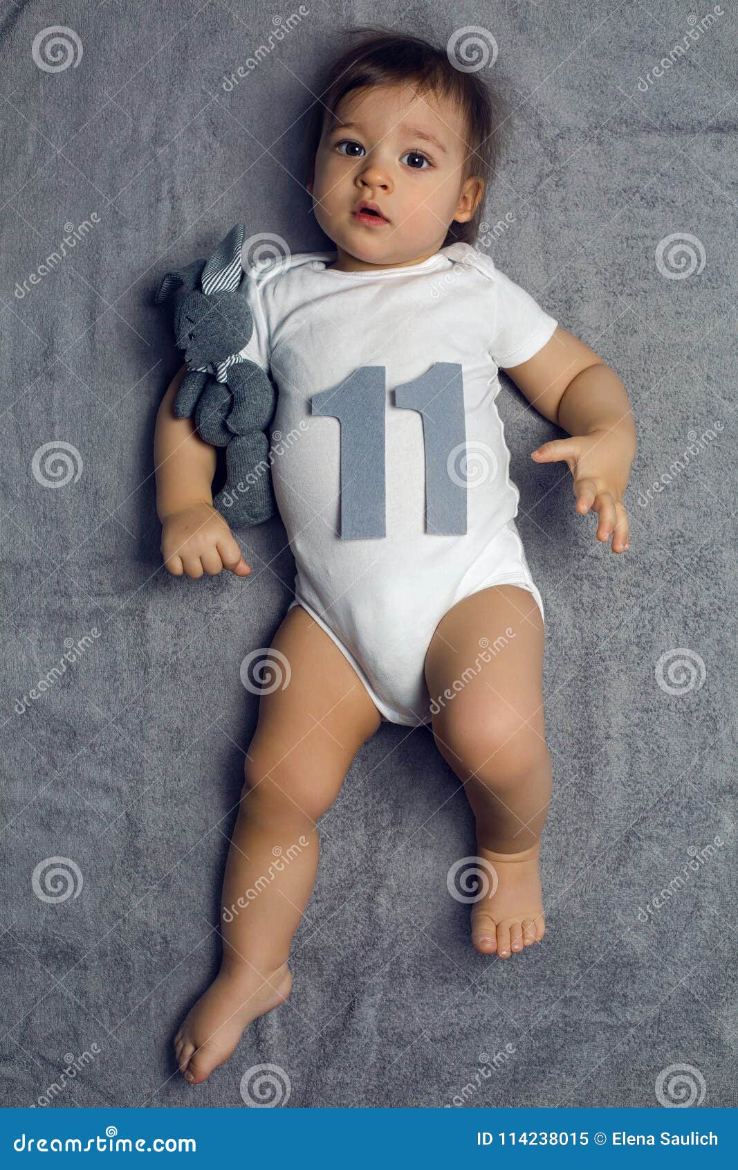 Newborn Baby Lying In Blue Jeans And A Black Scarf by Elena Saulich