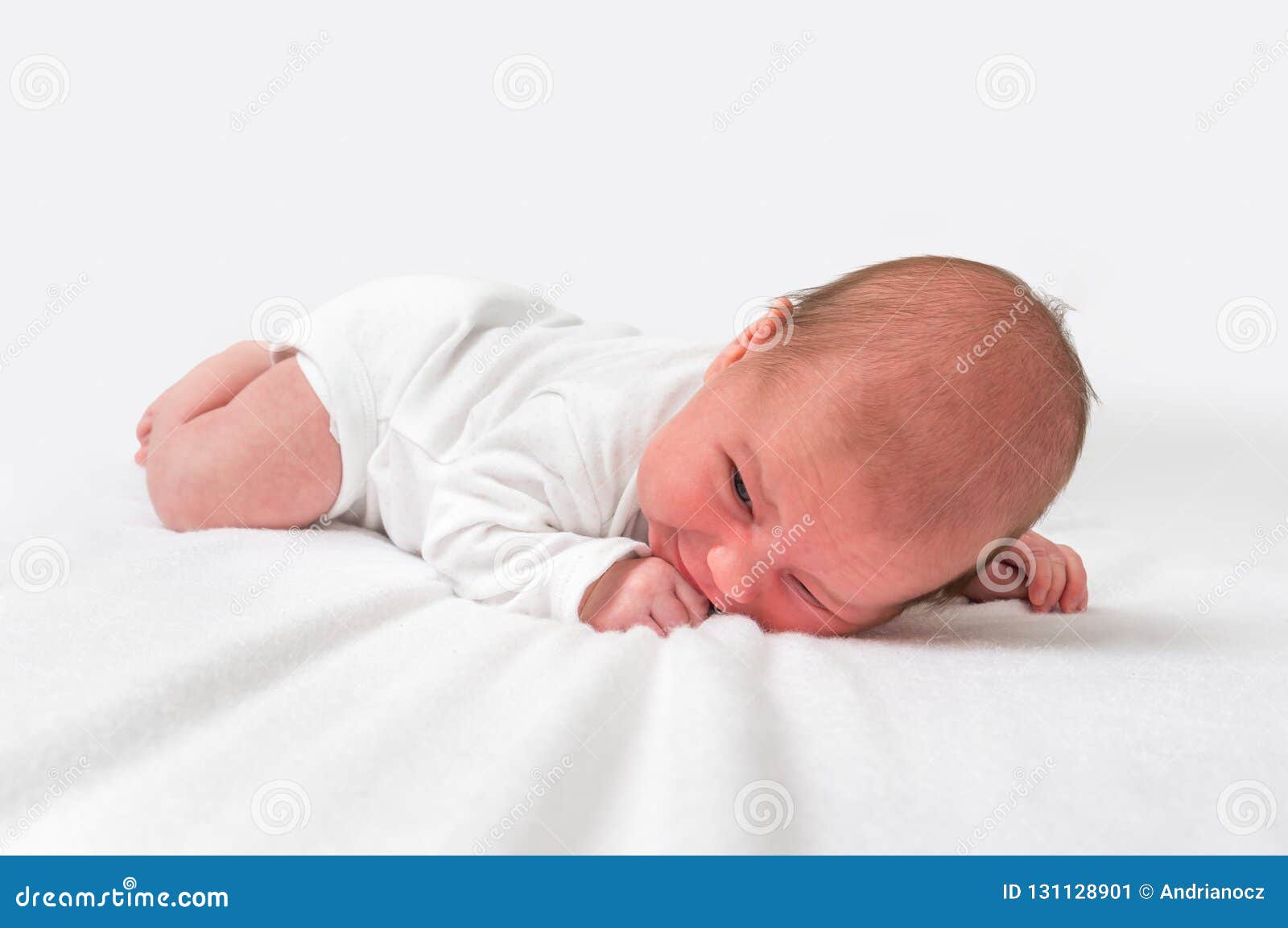 Naked Baby Lying On Belly Smiling Stock Photo | Getty Images