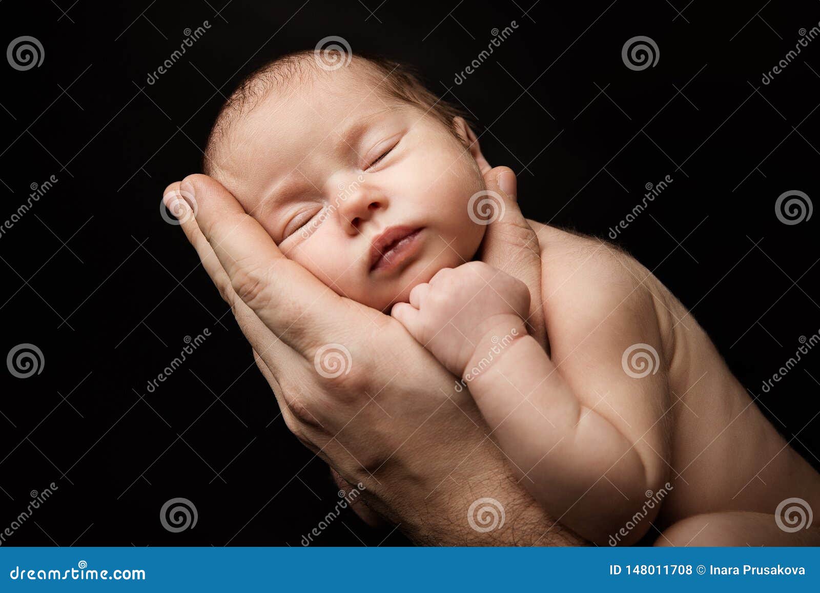 newborn baby sleeping on father hand, new born kid studio portrait