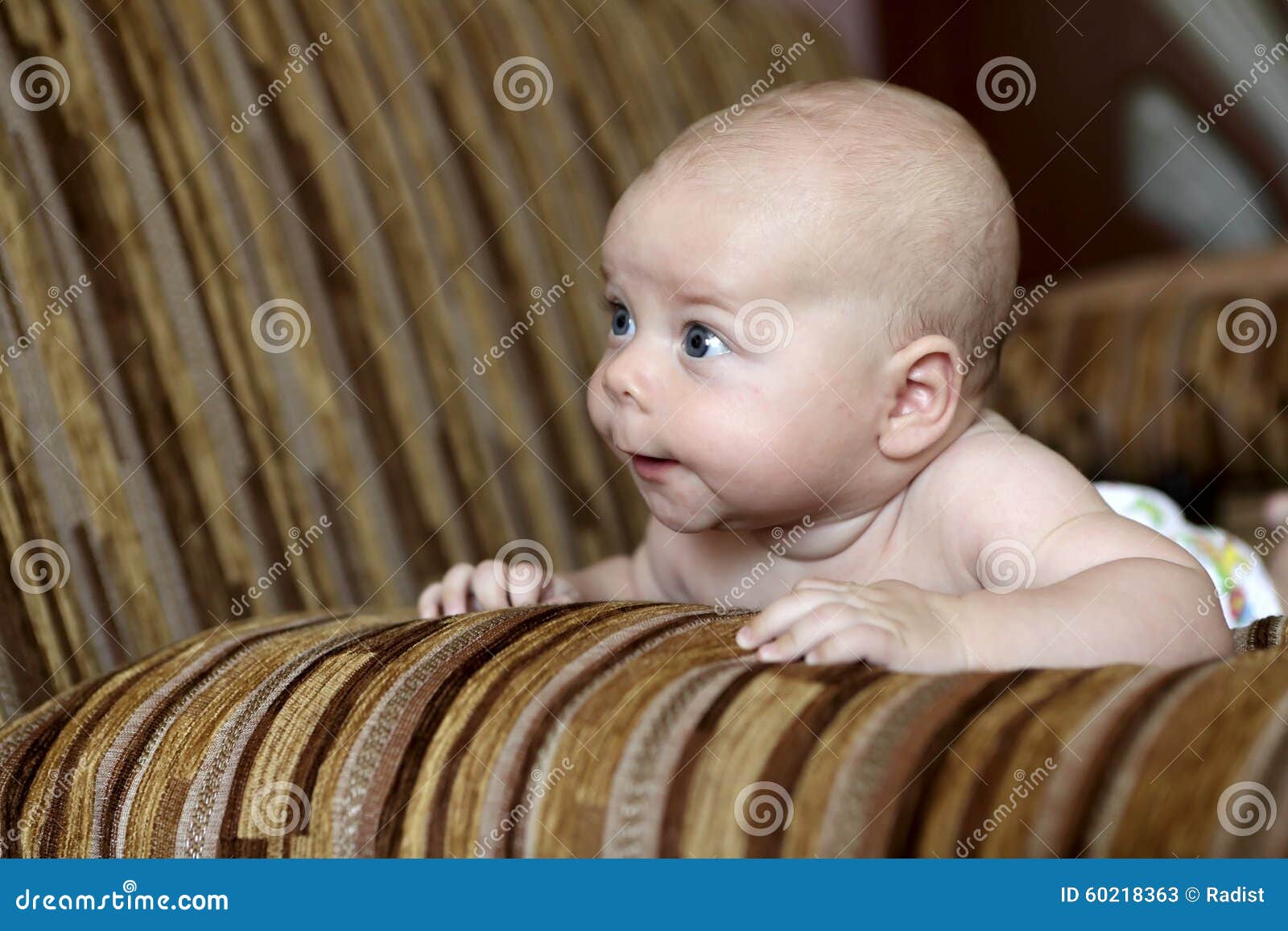 Newborn baby on the sofa stock image. Image of pensive 60218363