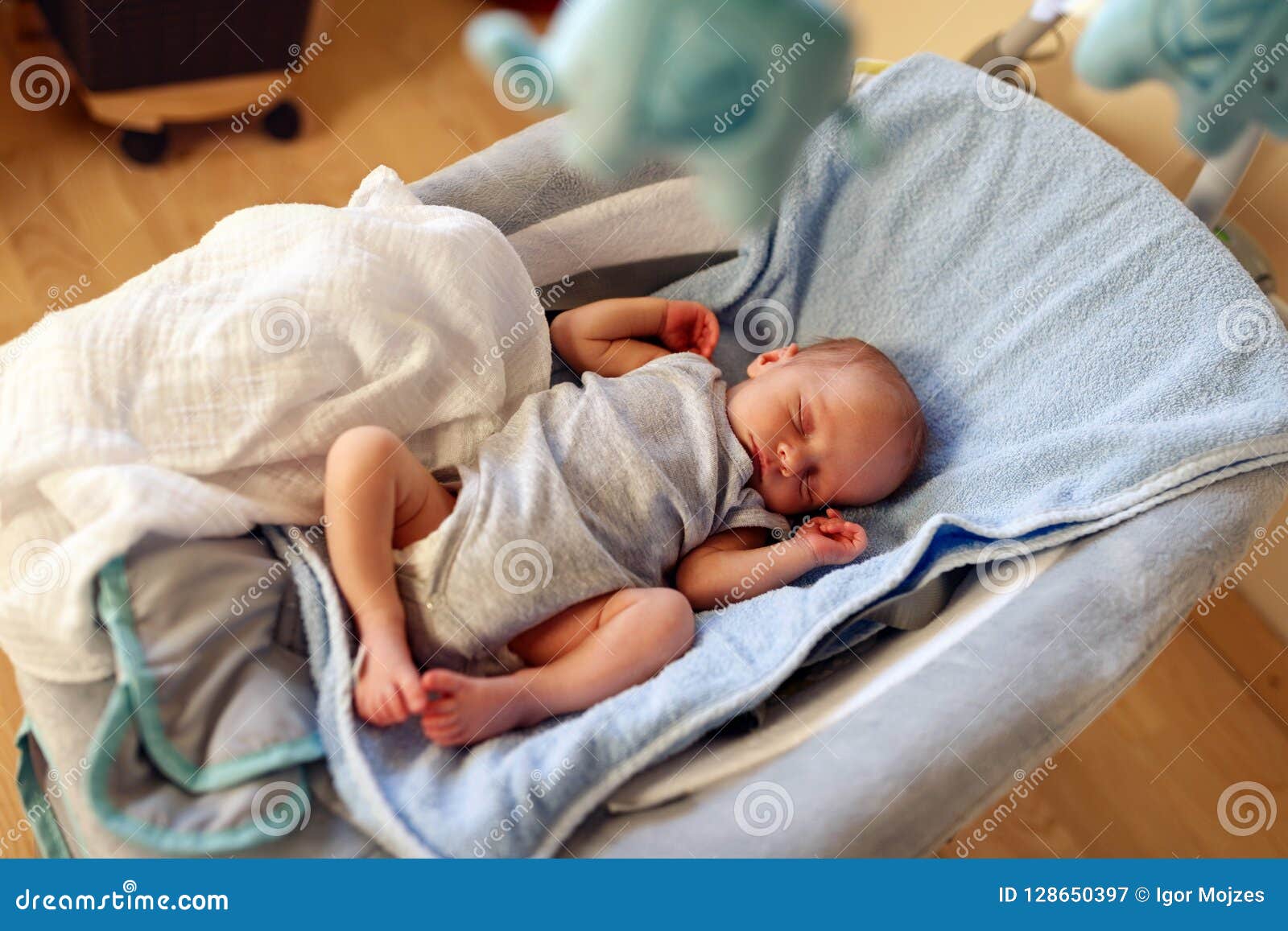 newborn sleeping in bouncer