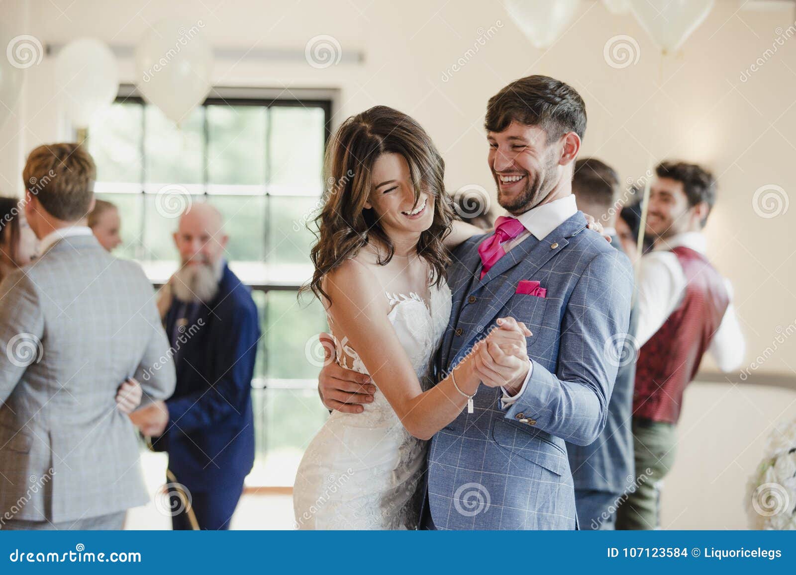 newly wed couple dancing with their guests