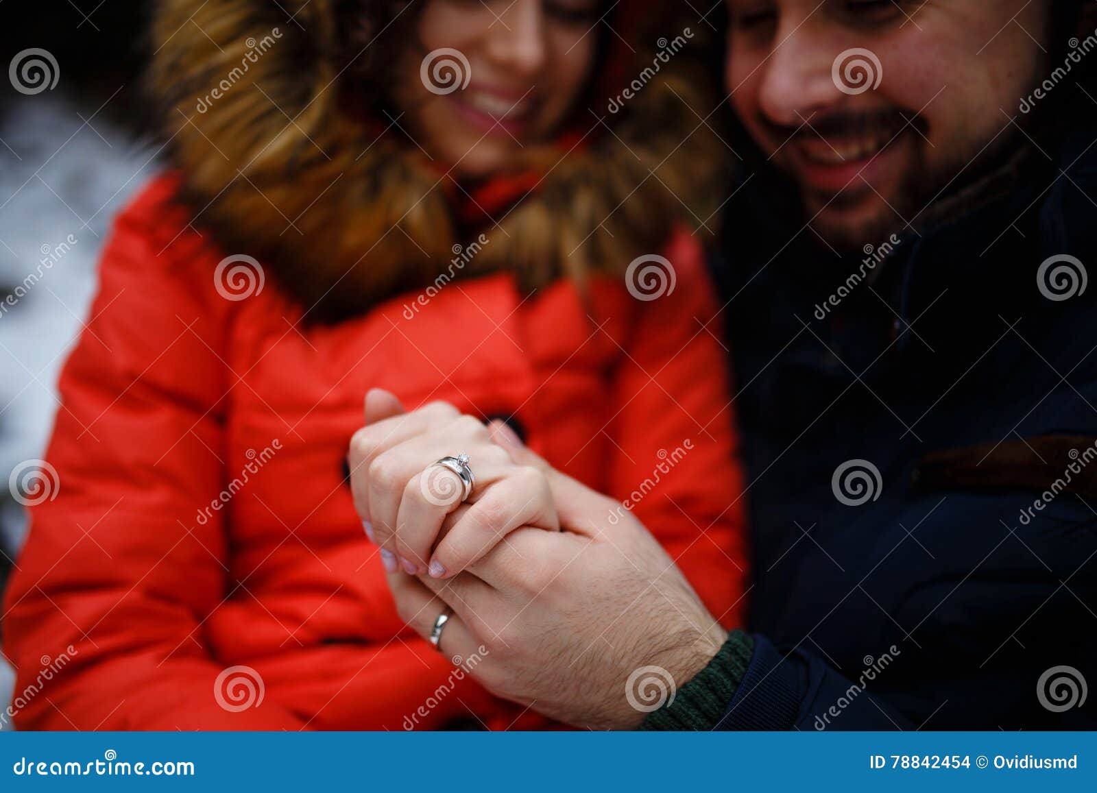 newly weds holding hands and showing wedding rings