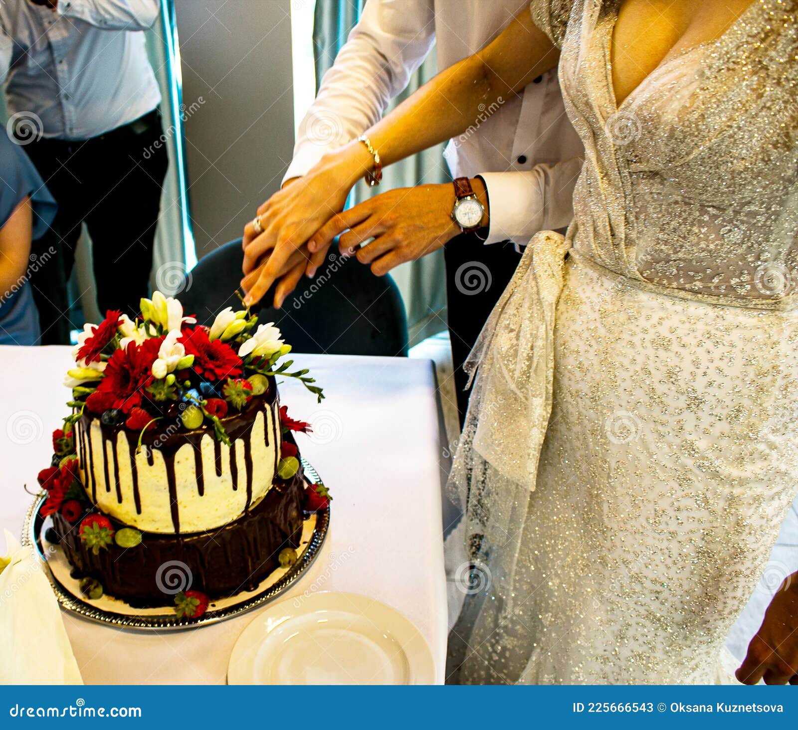 Newlyweds Cut the Wedding Cake. the Bride and Groom at the Wedding Cut