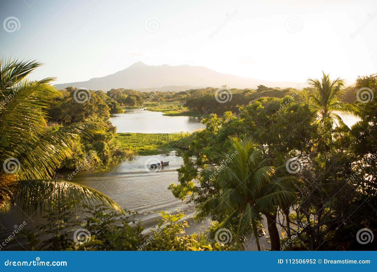 nicaragua lake and volcano with palm trees