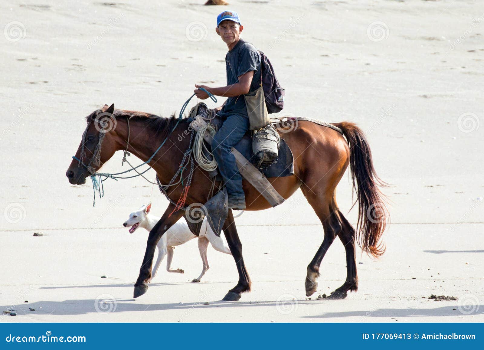 nicaraguan cowboy on horseback along a beach.