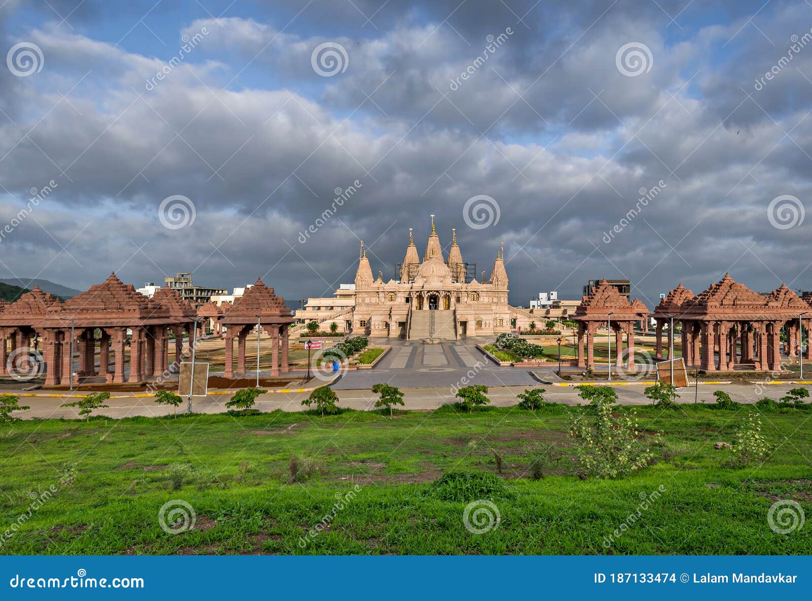 nice cloudscape over the campus of shree swaminarayan mandir, ambe gaon, pune .