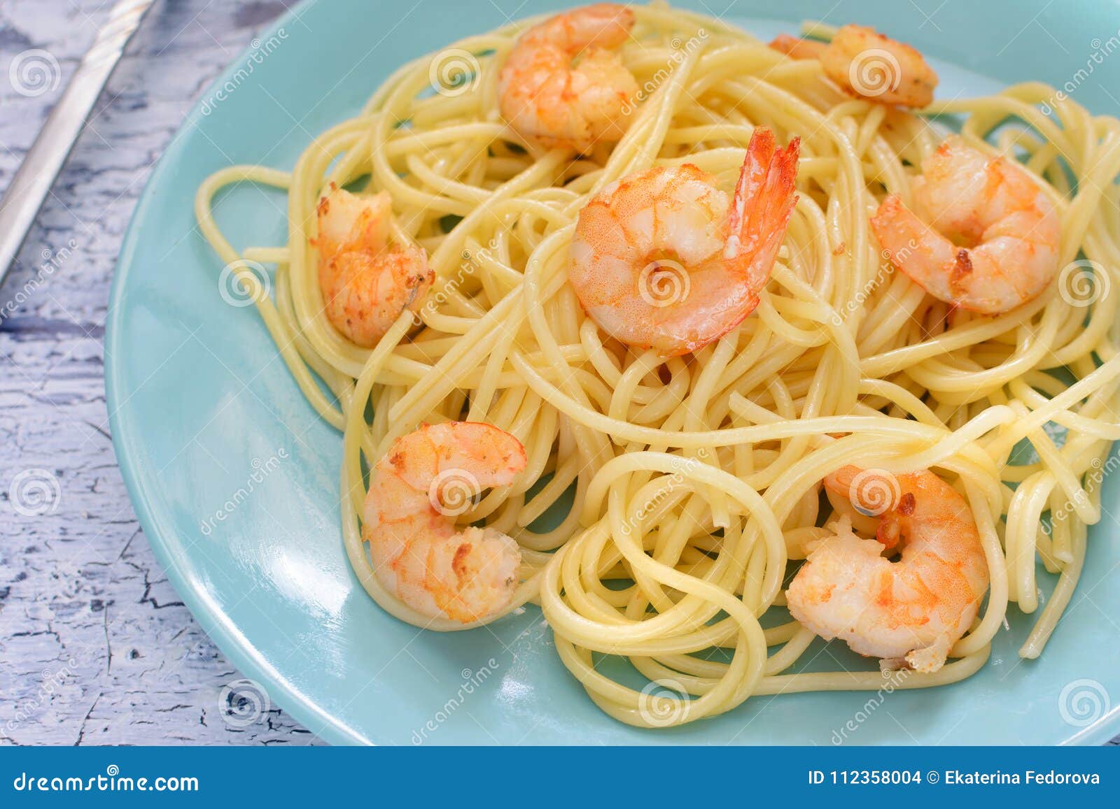 A Nice Delicious Dinner. Spaghetti with Shrimps on Blue Plates. Stock