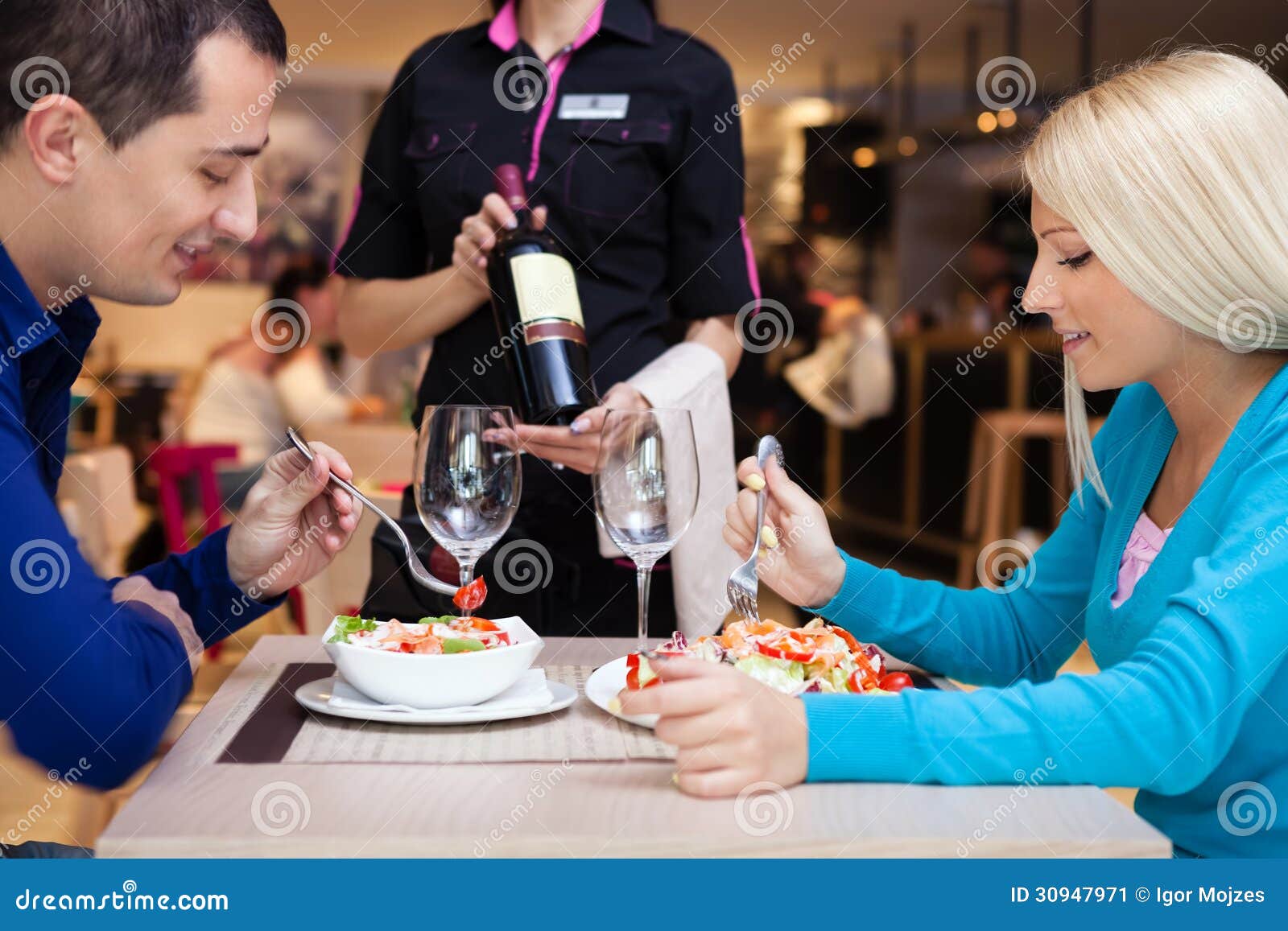 nice dinner in a restaurant - waiter offers wine