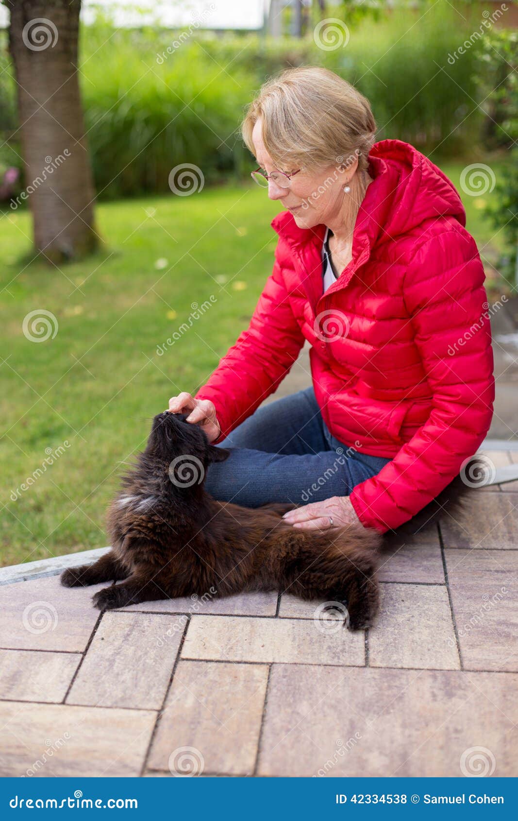 A Nice Elderly Woman Strokes Her Cat Passionately Stock Photo Image