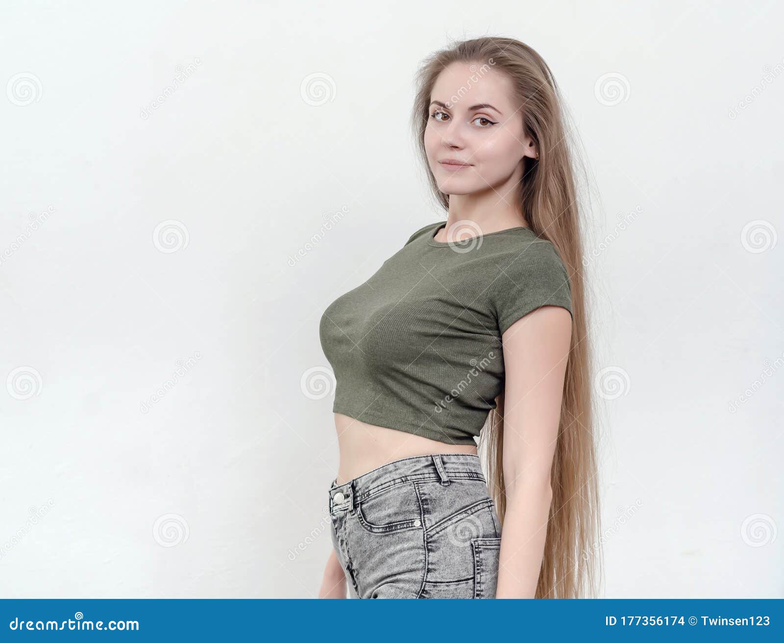 Nice Girl with Beautiful Breasts in a Green T-shirt Posing on Ca