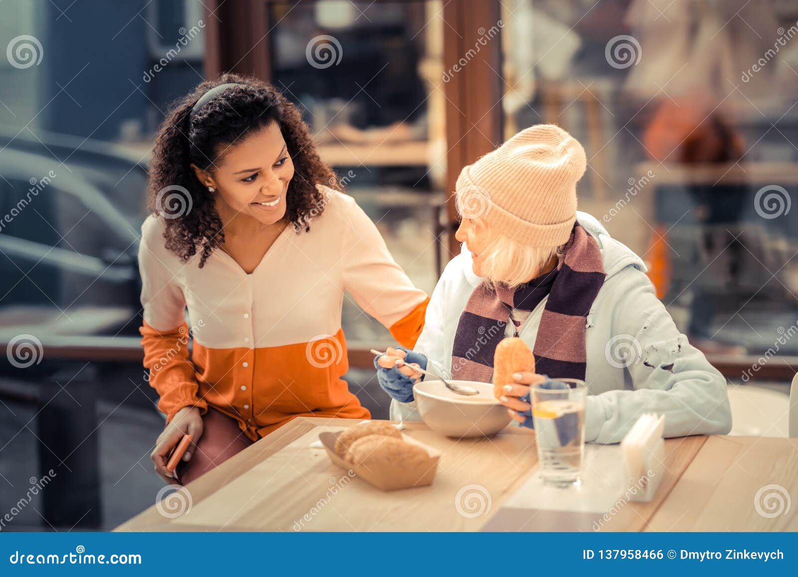 nice joyful woman helping poor homeless people