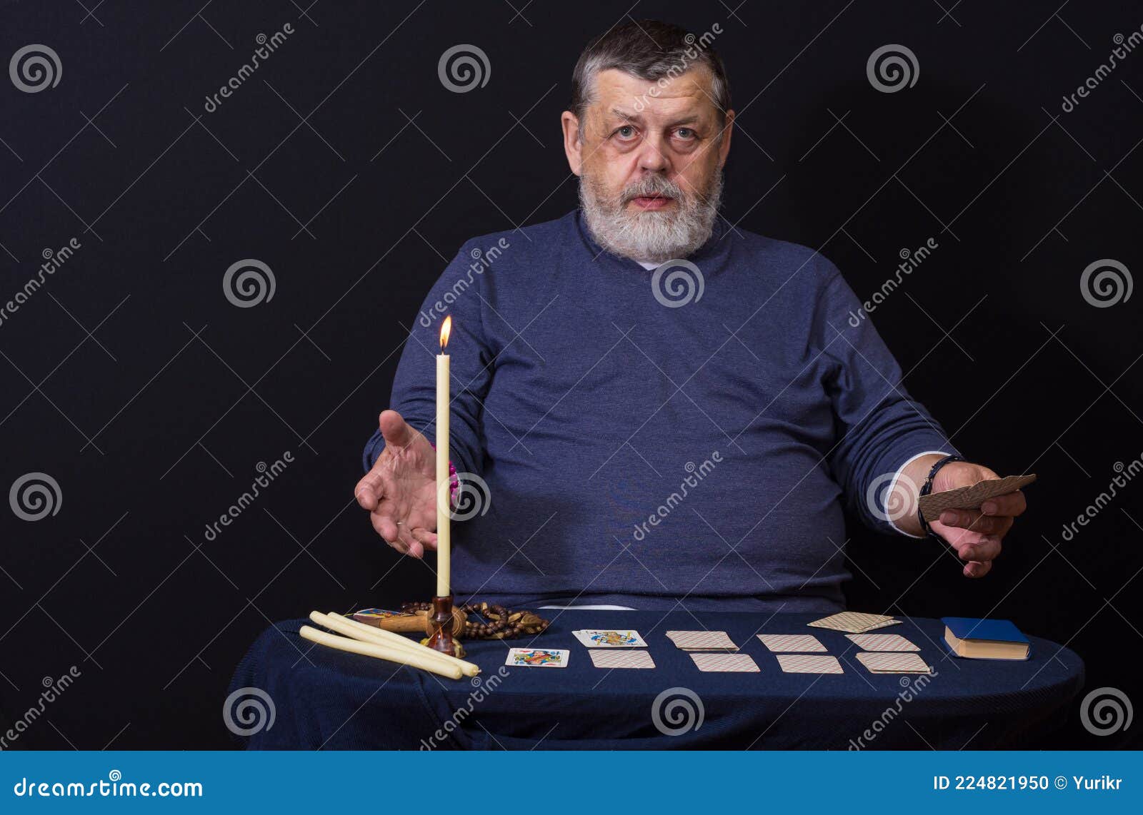 portrait of caucasian  senior man - soothsayer  while doing cartomancy