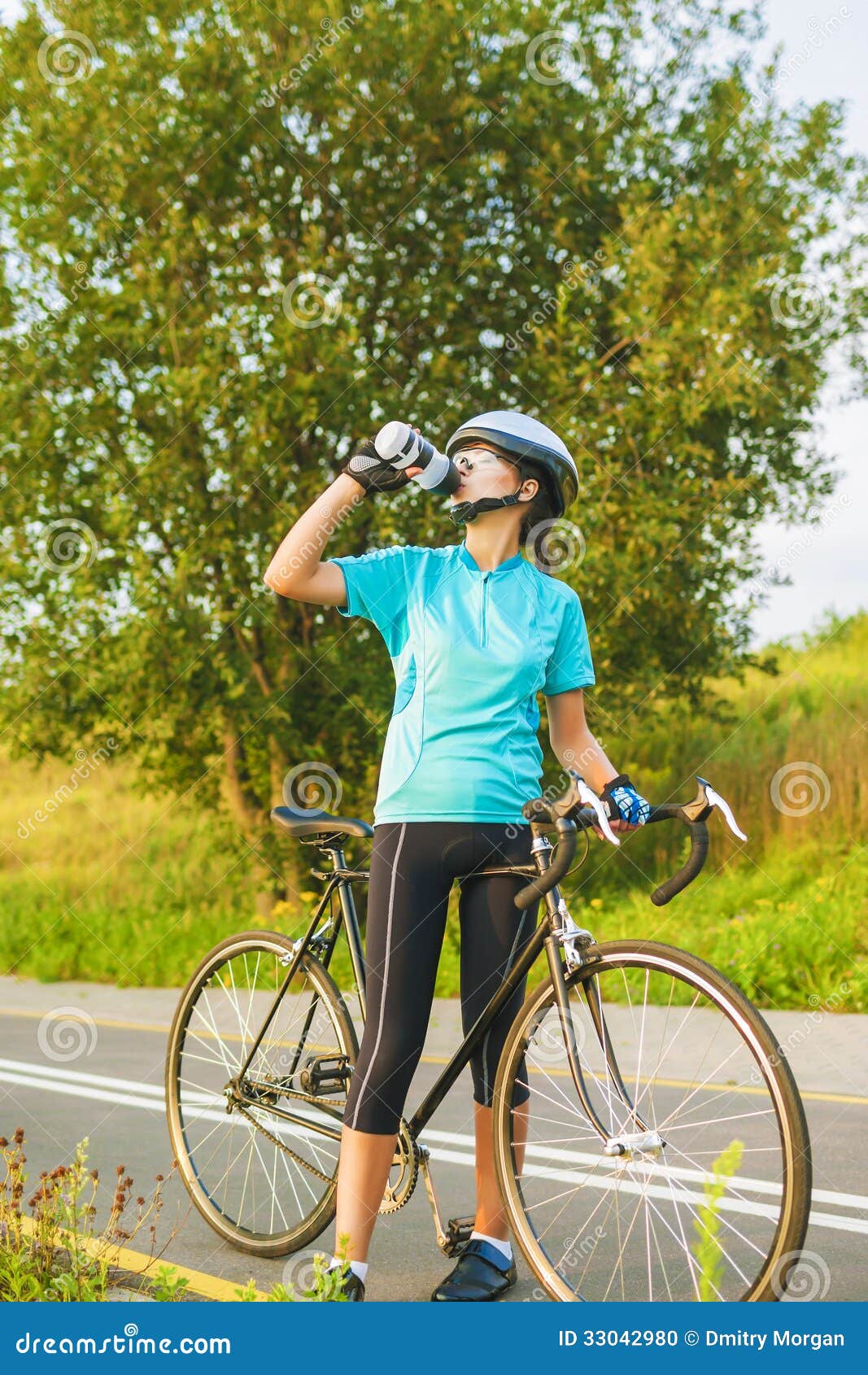 Nice Portrait of Young Female Cyclist Athlete Having a Break. Stock