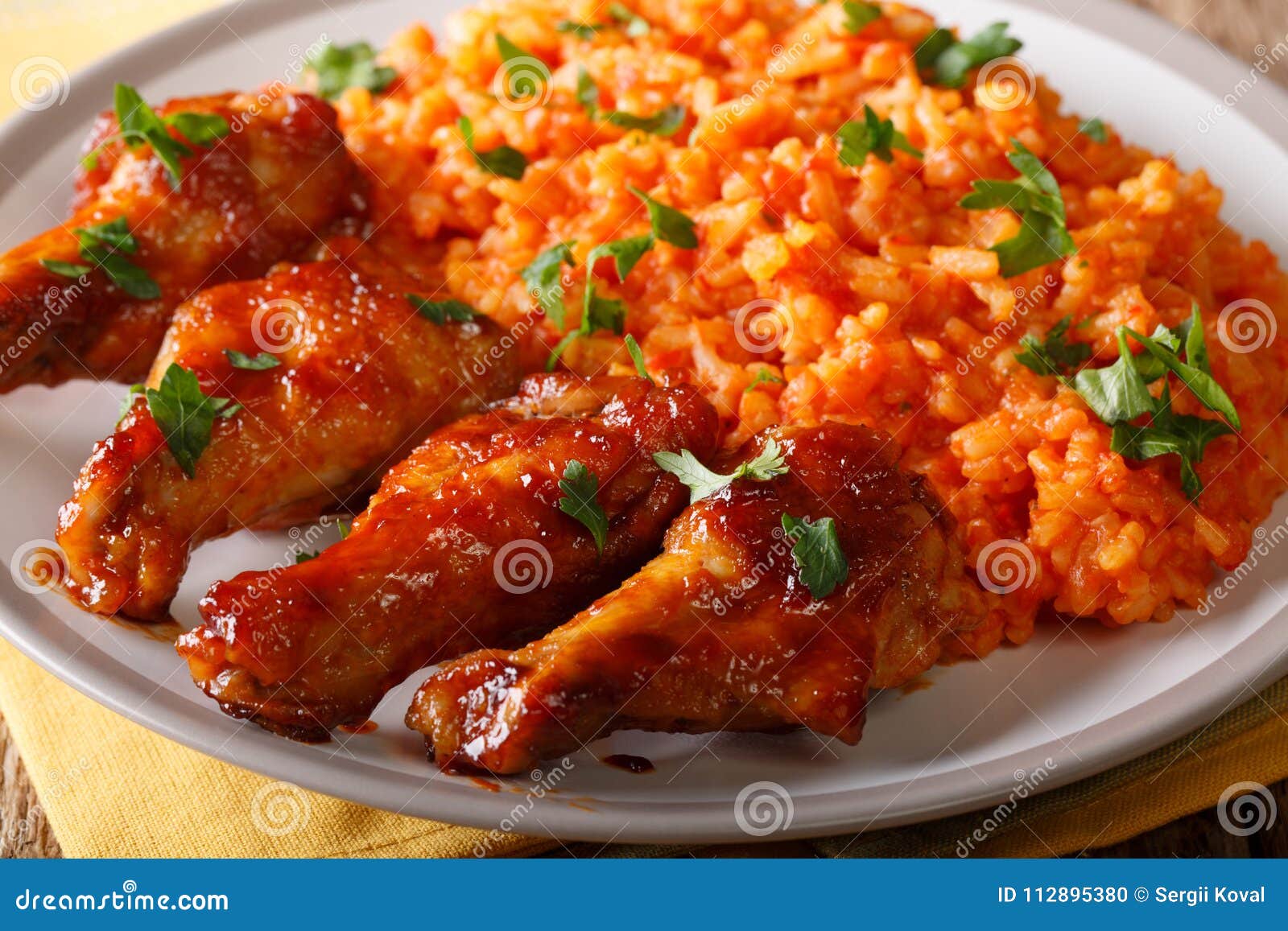 Nigerian Food: Spicy Jollof Rice with Fried Chicken Closeup. Horizontal