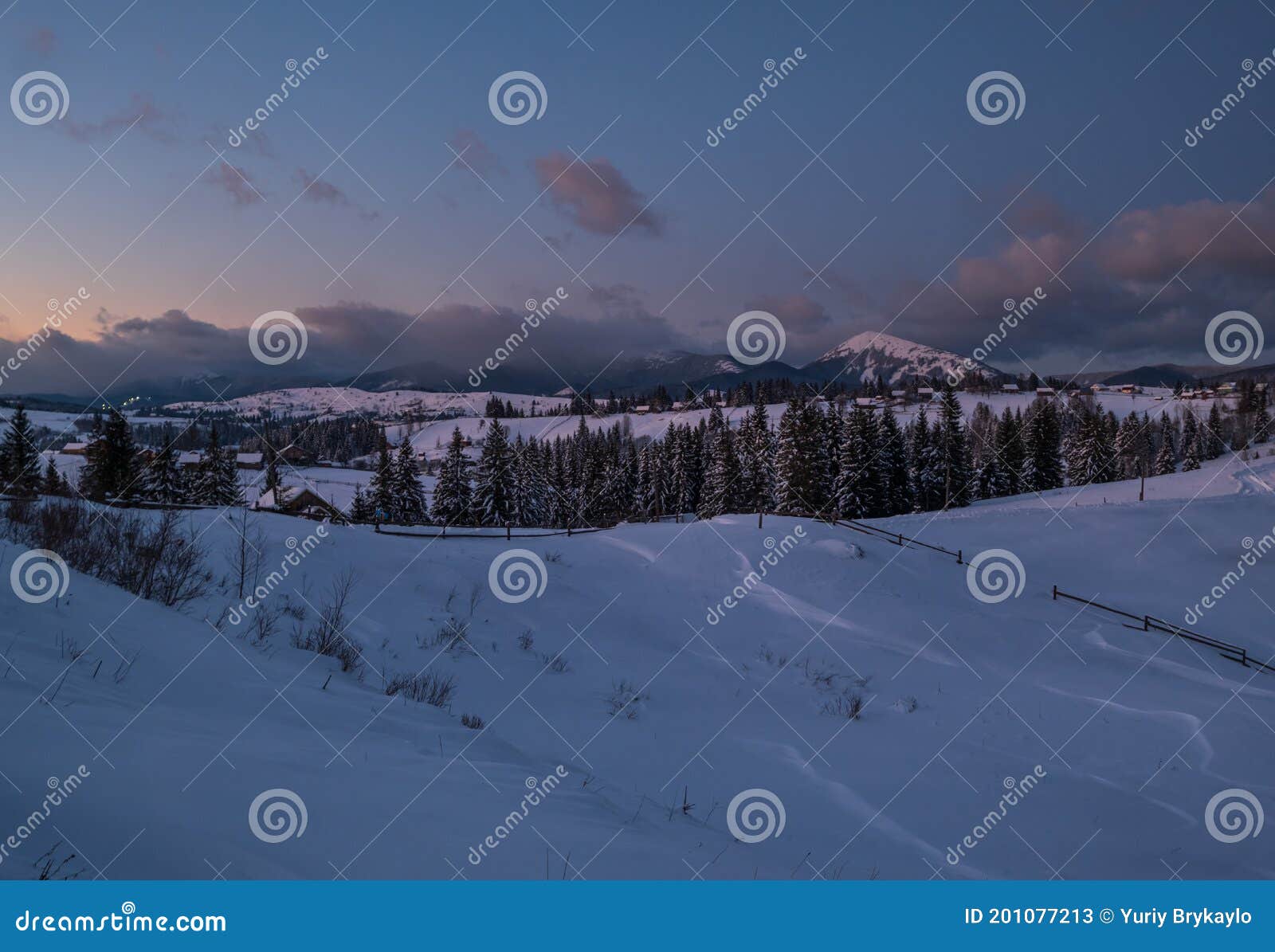 night countryside hills, groves and farmlands in winter remote alpine mountain village. ukraine, voronenko