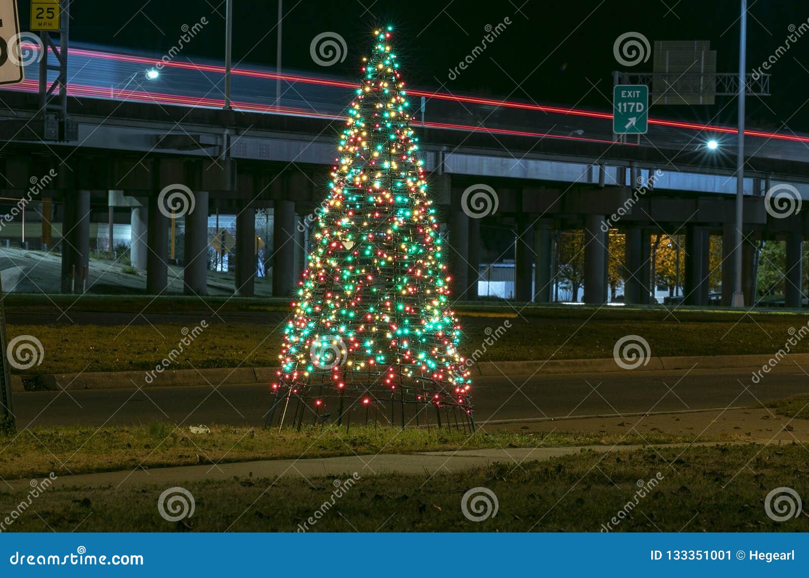 Night Image of a Lighted Christmas Tree Next To Interstate 20 Stock