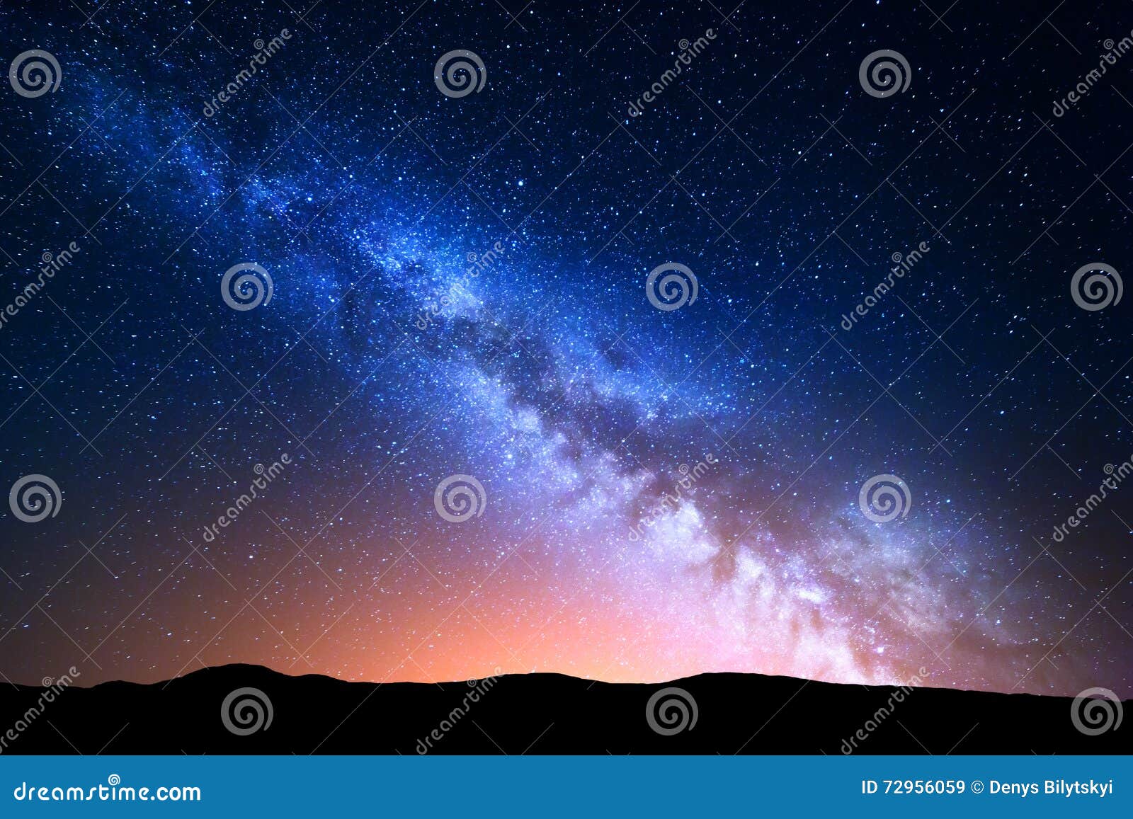 night landscape with colorful milky way and yellow light at mountains. starry sky with hills at summer. beautiful universe. space