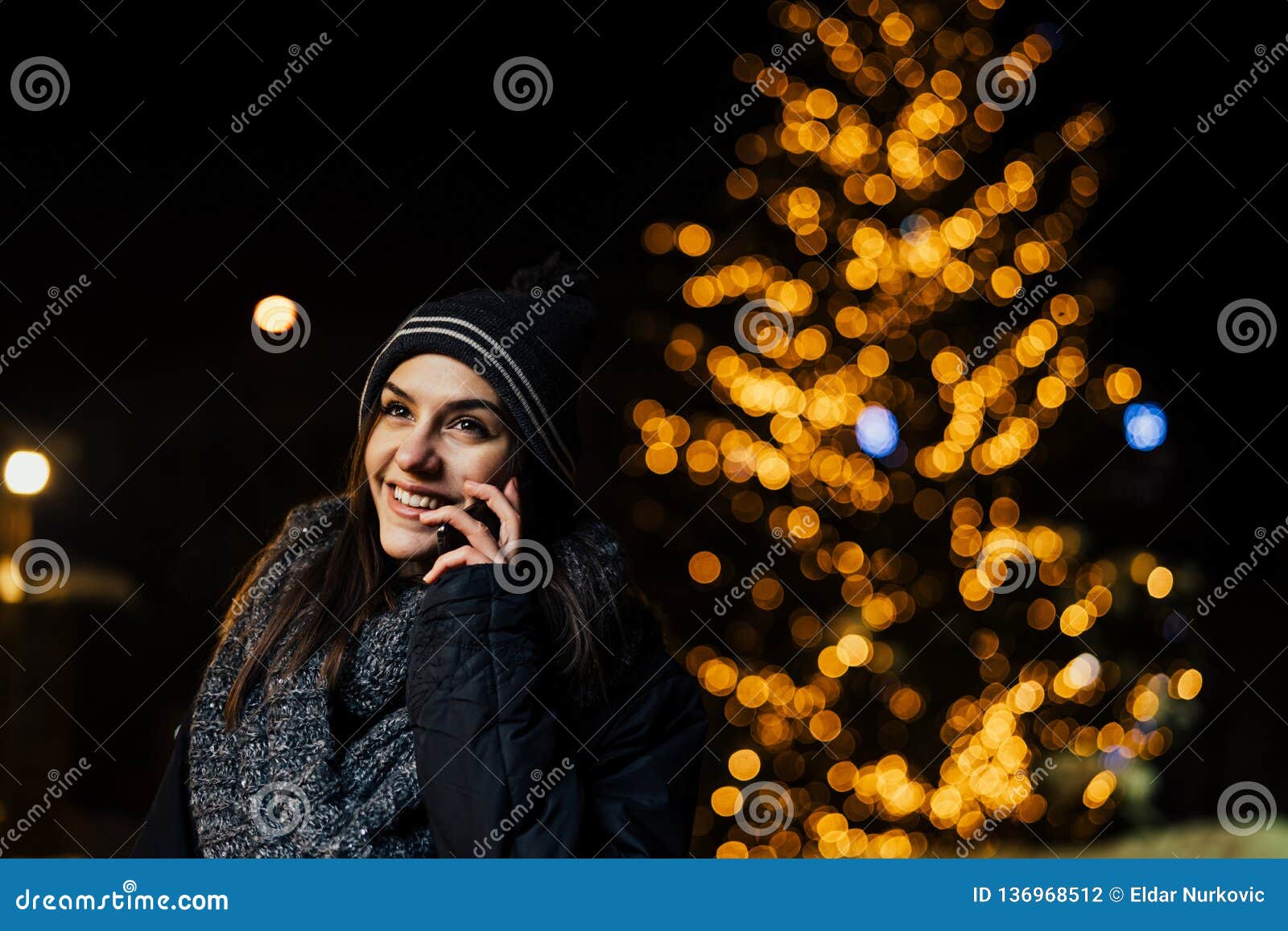 Night Portrait of a Beautiful Brunette Woman Using Smartphone during ...